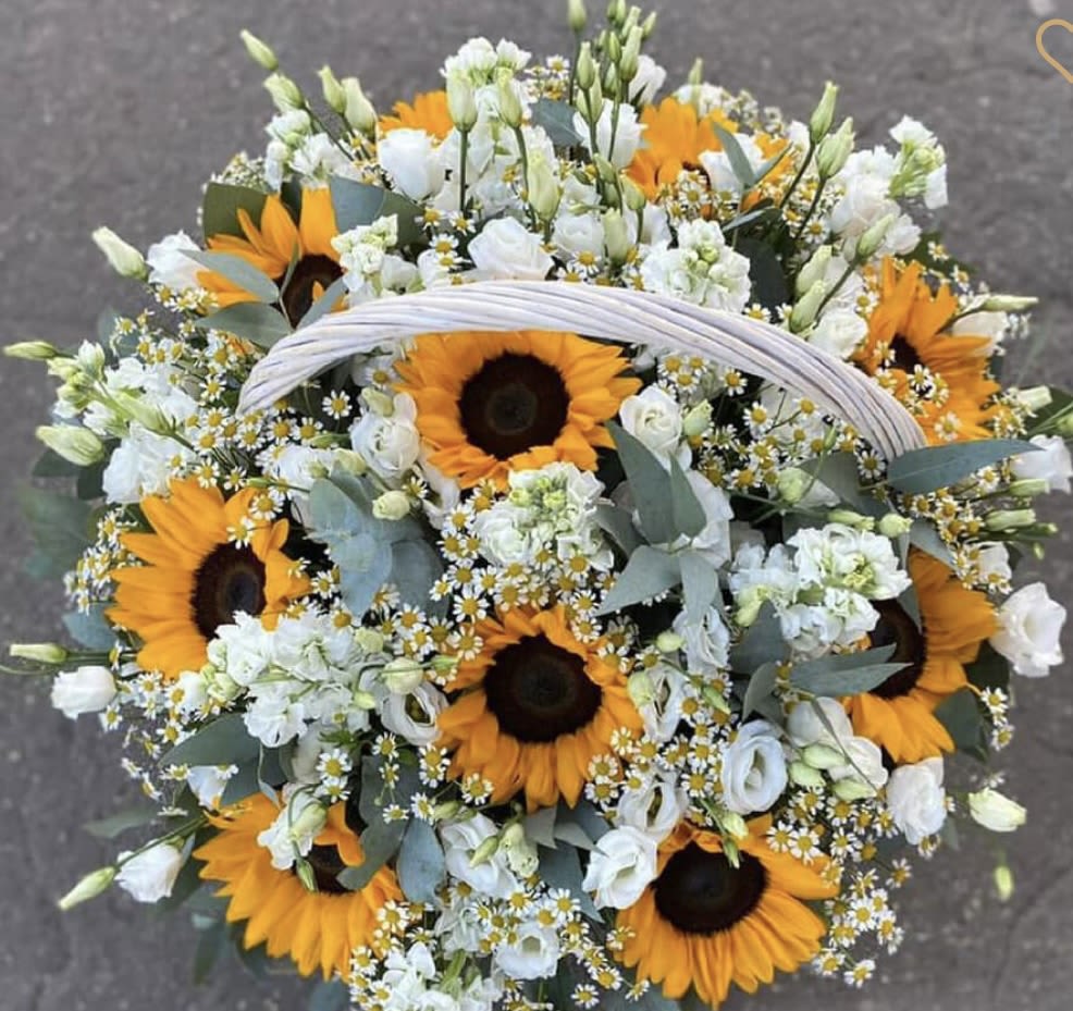 Sunflower Basket - Brighten any space with our &quot;Sunflower Basket.&quot; This cheerful arrangement features vibrant sunflowers, delicate lisianthus, and charming daisies, all beautifully nestled in a rustic basket. Perfect for bringing warmth and joy to any occasion, this bouquet captures the essence of summer and happiness. Whether as a gift or a lovely addition to your home, it radiates positivity and cheer, making every day feel like a sunny celebration!