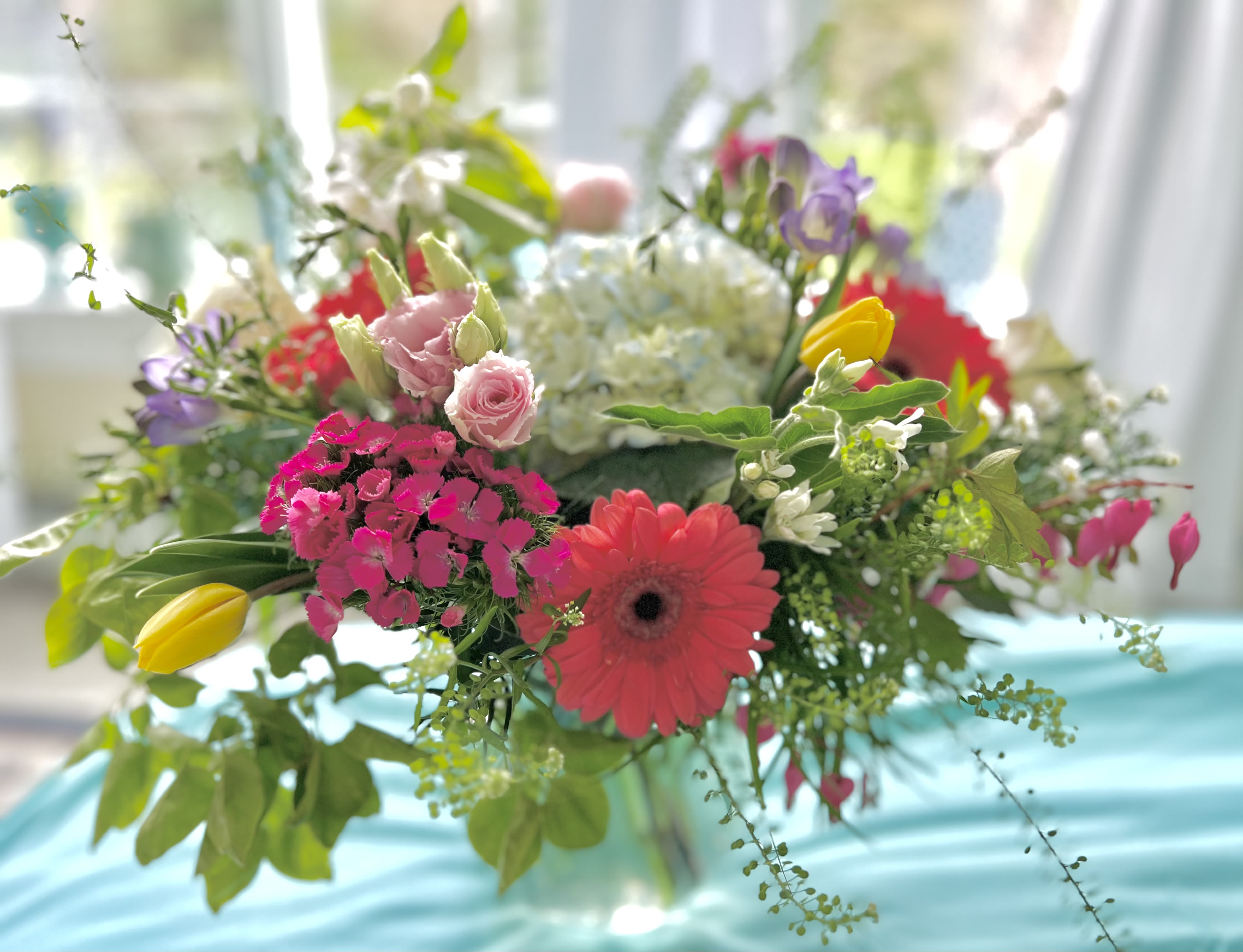 To brighten your day To brighten your day - A vibrant display of spring like blooms - it will make someone’s heart dance for sure