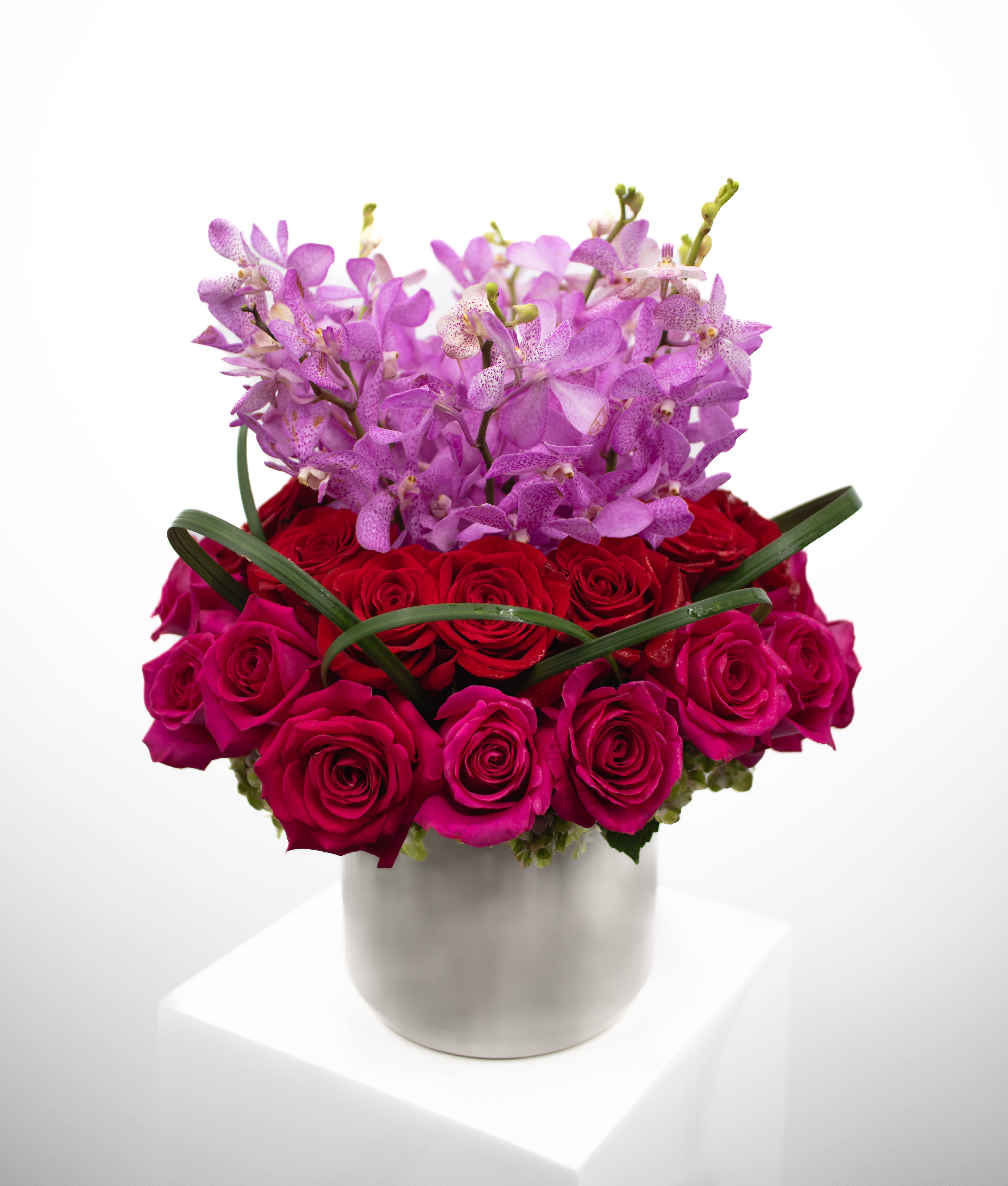 June - Introducing June – a luxurious masterpiece that combines the timeless elegance of two dozen roses with the exotic beauty of stunning purple or pink orchid stems, all artfully arranged in a sizable vase. Radiating opulence and charm, June is the epitome of sophistication, perfect for making a grand gesture or celebrating life's special moments in style. 