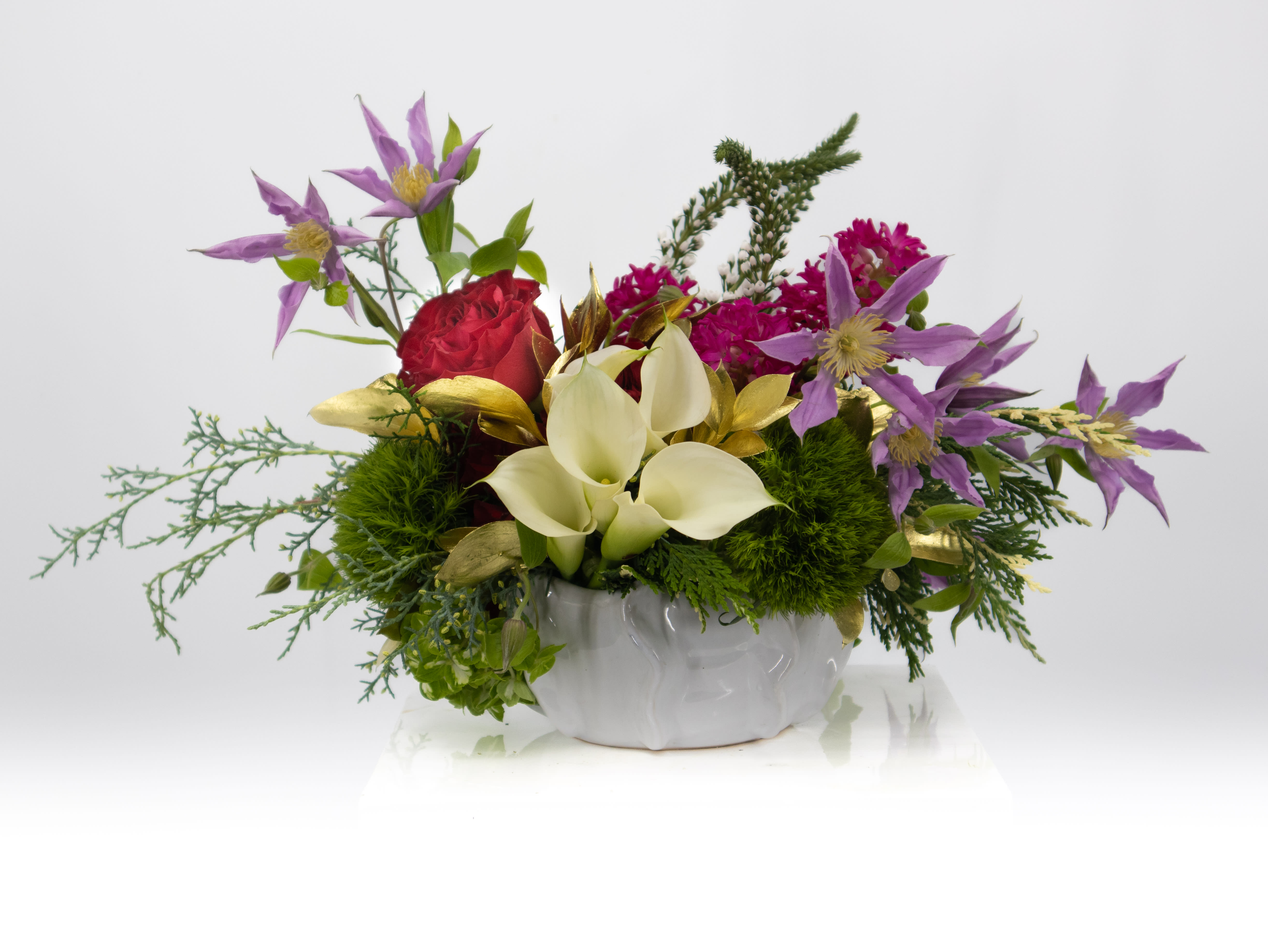 Shirley Shirley - A arrangement for any day, that is what Shirley provides. Styled in a lovely short vase one would think you wouldn't be able to fit the beauty that we have. From Rose's and fresh hydrangeas to Calla lilies and lush greenery. This piece will fill any need for any occasion.