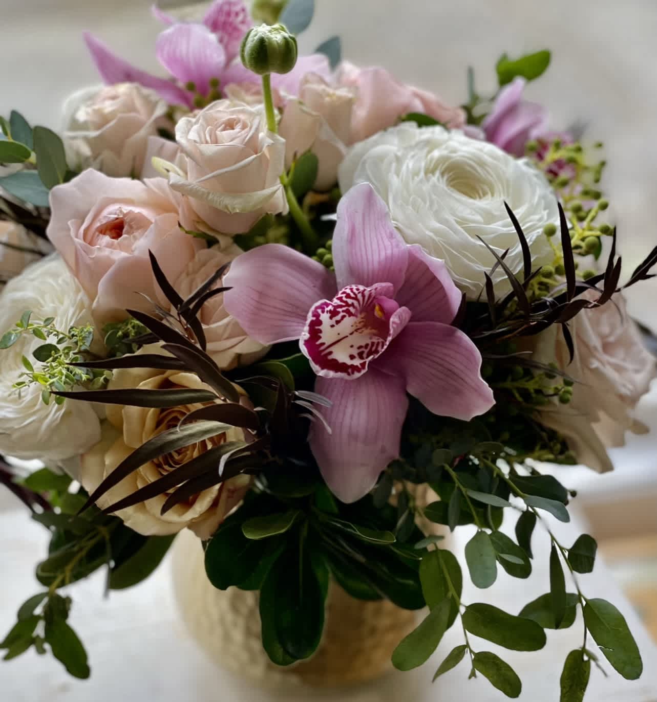 Lean Into My Kiss  - Elegant, classy, subtle, soft. Pale pink and white blooms accented with dark pink orchids in a gold vase.   Perfect flowers for birthdays, &quot;get well soon,&quot; new baby, sympathy, congratulations, romantic gestures, and &quot;Thank you.&quot; Also a beautiful wedding palette.  Available for delivery in Seattle, Bellevue, Shoreline, and surrounding areas. Available for delivery in all neighborhoods in Seattle including Magnolia, Ballard, Fremont, Downtown, Queen Anne, Crown Hill, U District, West Seattle, International District, Capitol Hill, Pioneer Square, Beacon Hill, Columbia City, Georgetown, etc. 