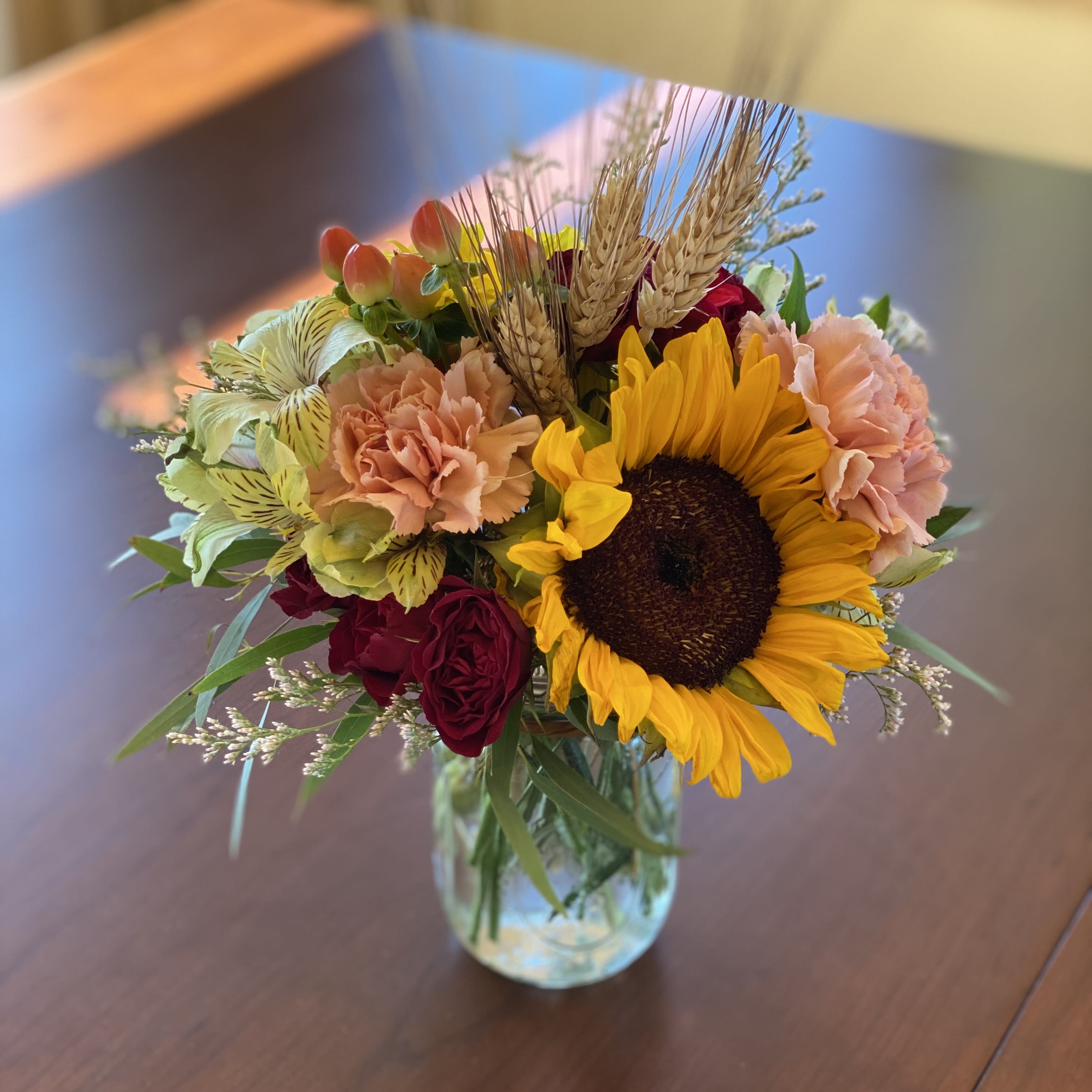 The Savannah Bouquet - A lovely gift to celebrate Autumn and the colors it brings to life. This bouquet fits nicely on a desk, nightstand or kitchen counter and makes a great thank you or welcome home gift. Bring the golden hues of Autumn indoors. Designed in a mason jar with a sweet raffia ribbon.   *Please remember that the photos depict a sample arrangement in an overall design style. There are no guarantees that your gift arrangement will look identical to these photos. Tama will do her very best to duplicate the arrangement exactly.