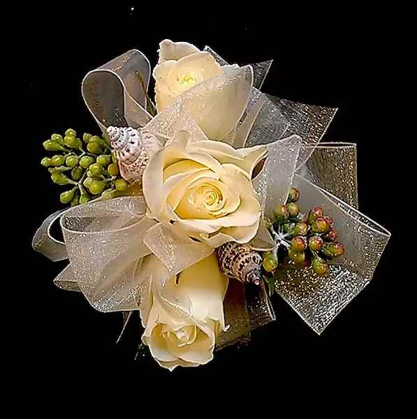Seaside Rose Corsage - Whether your event is near the ocean or not, this beautiful rose corsage with seashells, seeded Eucalyptus or other greens will be a hit! Choose as a pin on or wrist corsage and add your choice of wrist bands. Specify preferred color or roses and ribbon in comments section of order form. NOTE: WRIST CORSAGE BEADED AND CRYSTAL BANDS SOLD SEPARATELY. PLEASE CHOOSE PREFERRED BAND AND ADD TO ORDER. All Boutonnieres and Corsages should be ordered a minimum of 3 - 5 days prior to your event. For needs sooner than that please call the store at 858-454-0146 to ensure availability.  All prices in USD ($)