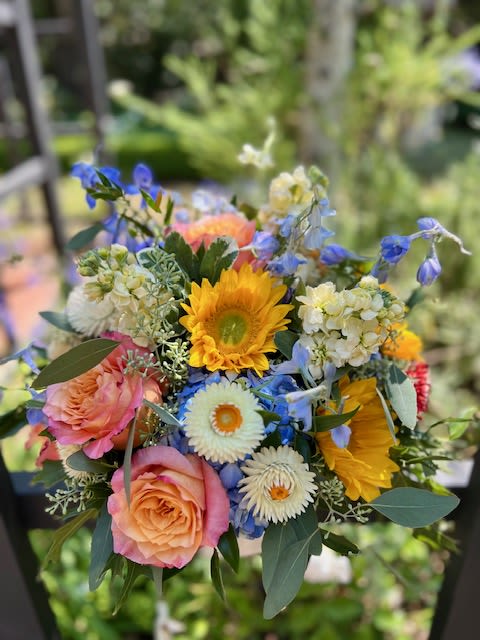 Under the Tuscan Sun Under the Tuscan Sun - featuring blue delphinium and yellow stock nestled amongst hydrangeas, sunflowers, orange roses, and strawflower, perfect for any occasion!