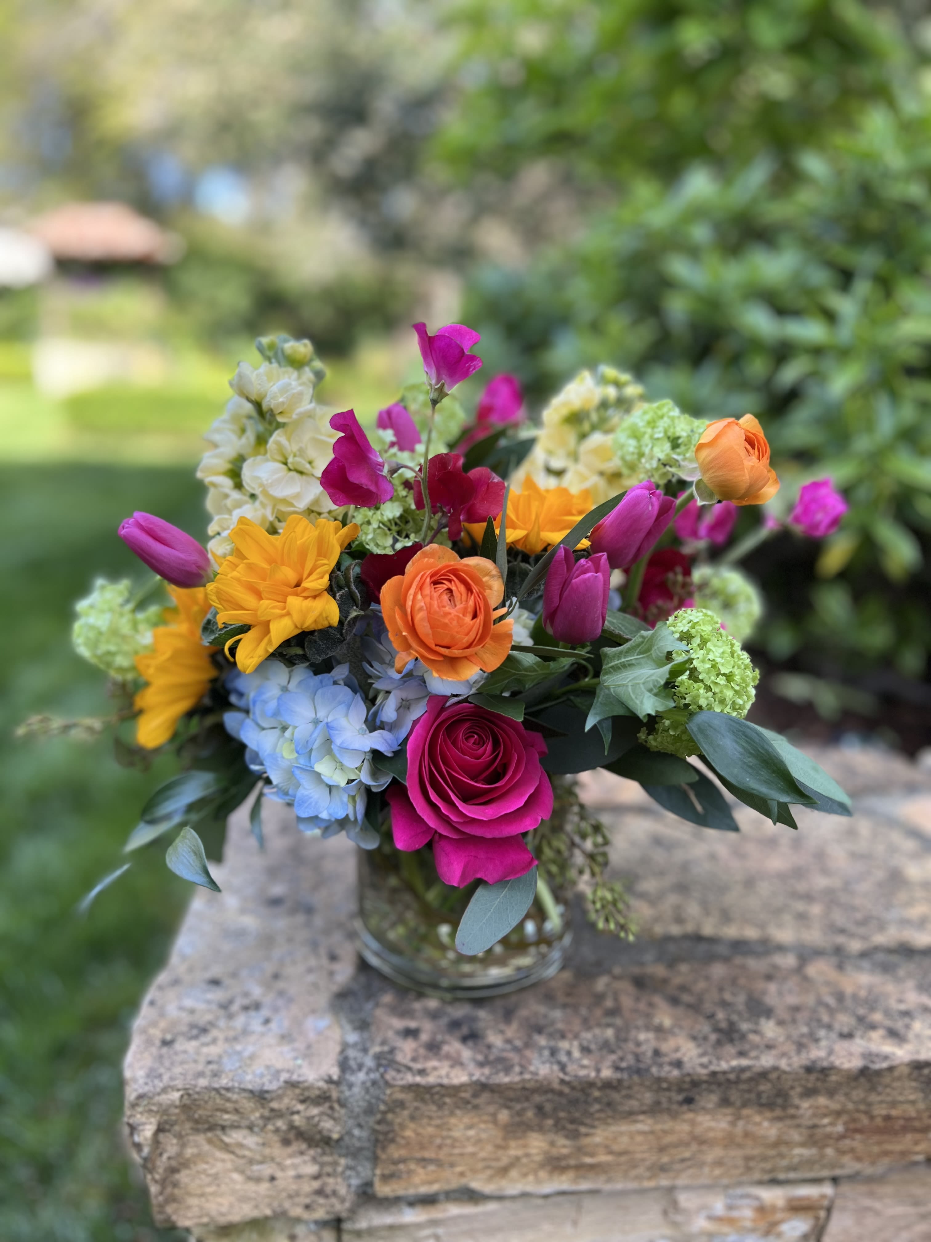 Rainbow Road Rainbow Road - Cheerful sunflowers and hot pink roses make up this vibrant mix with bright colorful blooms.