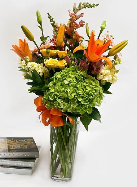 Bright Lights - Looking to brighten up a room, or someone you know and love? This will light up their day, or that corner of your room that screams for attention. A tall beautiful mix of seasonal flowers and hydrangea are arranged in a clear glass vase. Sure to put a smile and anyone's face!  All prices in USD ($)