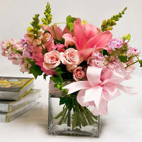 Pink Cabana - The glow of this amazing arrangement of roses, lilies, and other seasonal flowers and greens will delight anyone's senses.