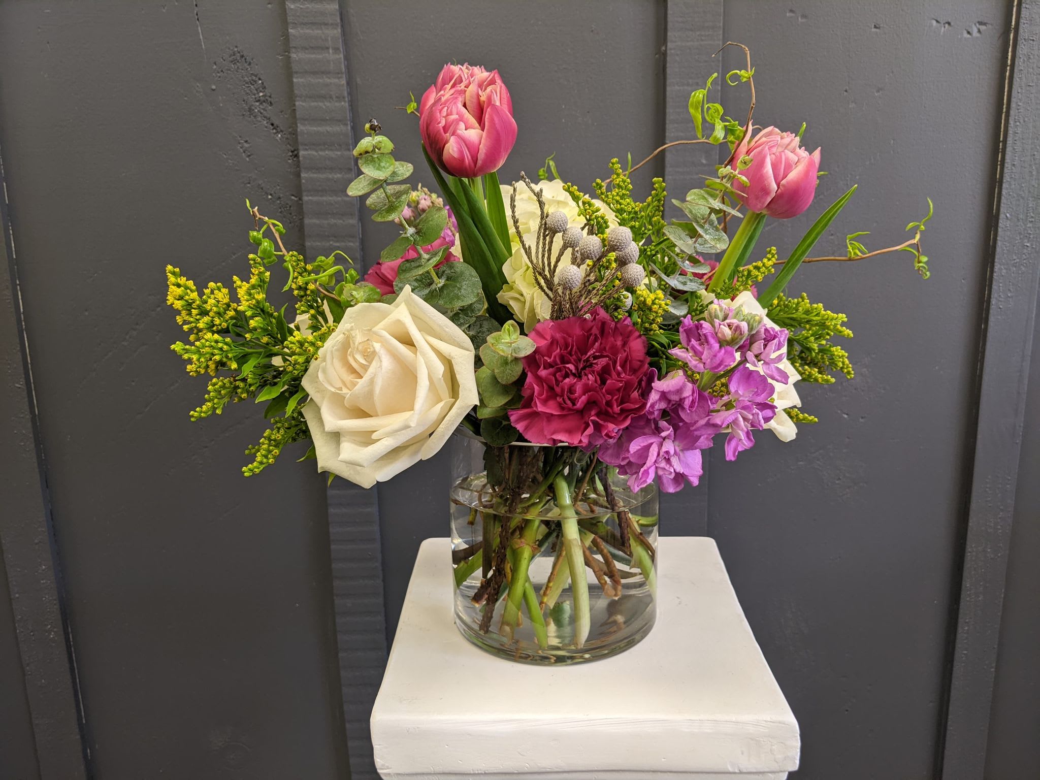 Berry Burst - A stunning modern spring arrangement featuring tulips, fragrant stock, and complementing roses. A perfect arrangement to send to that special person in your life.