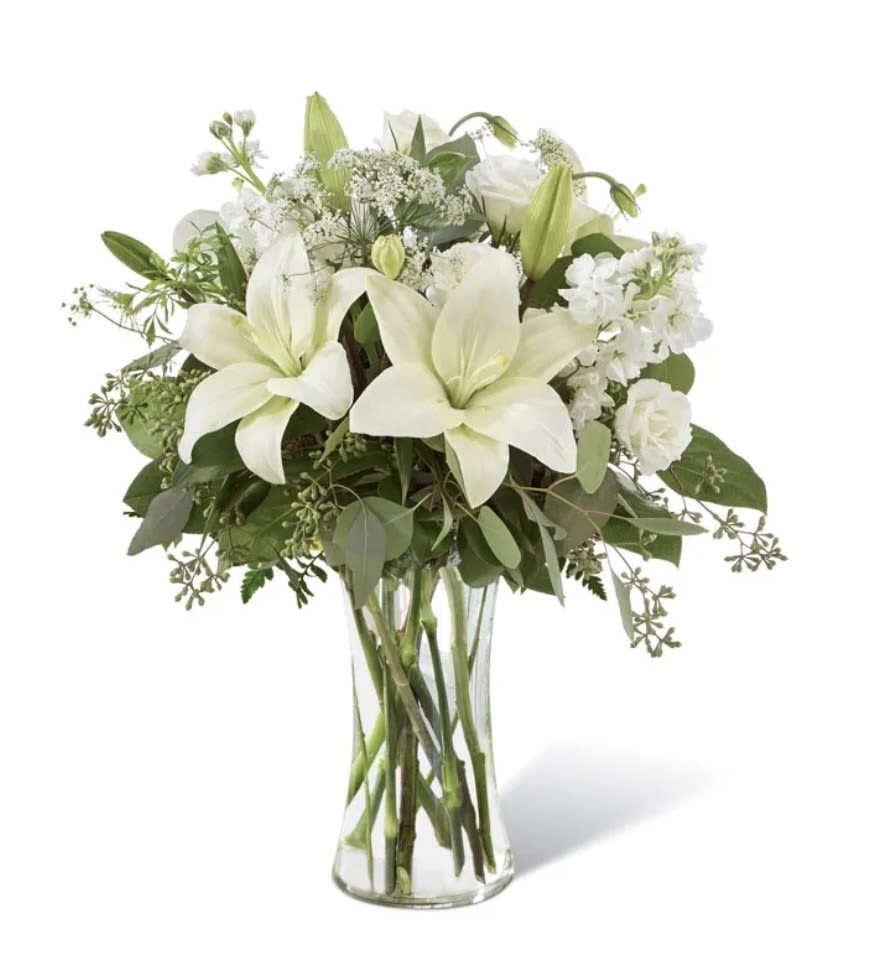 White Wonder - A serene and elegant arrangement of white lilies, accented with delicate greenery. This bouquet is a symbol of purity and peace, making it a perfect choice for sympathy, congratulations, or any occasion where you want to express your heartfelt sentiments.