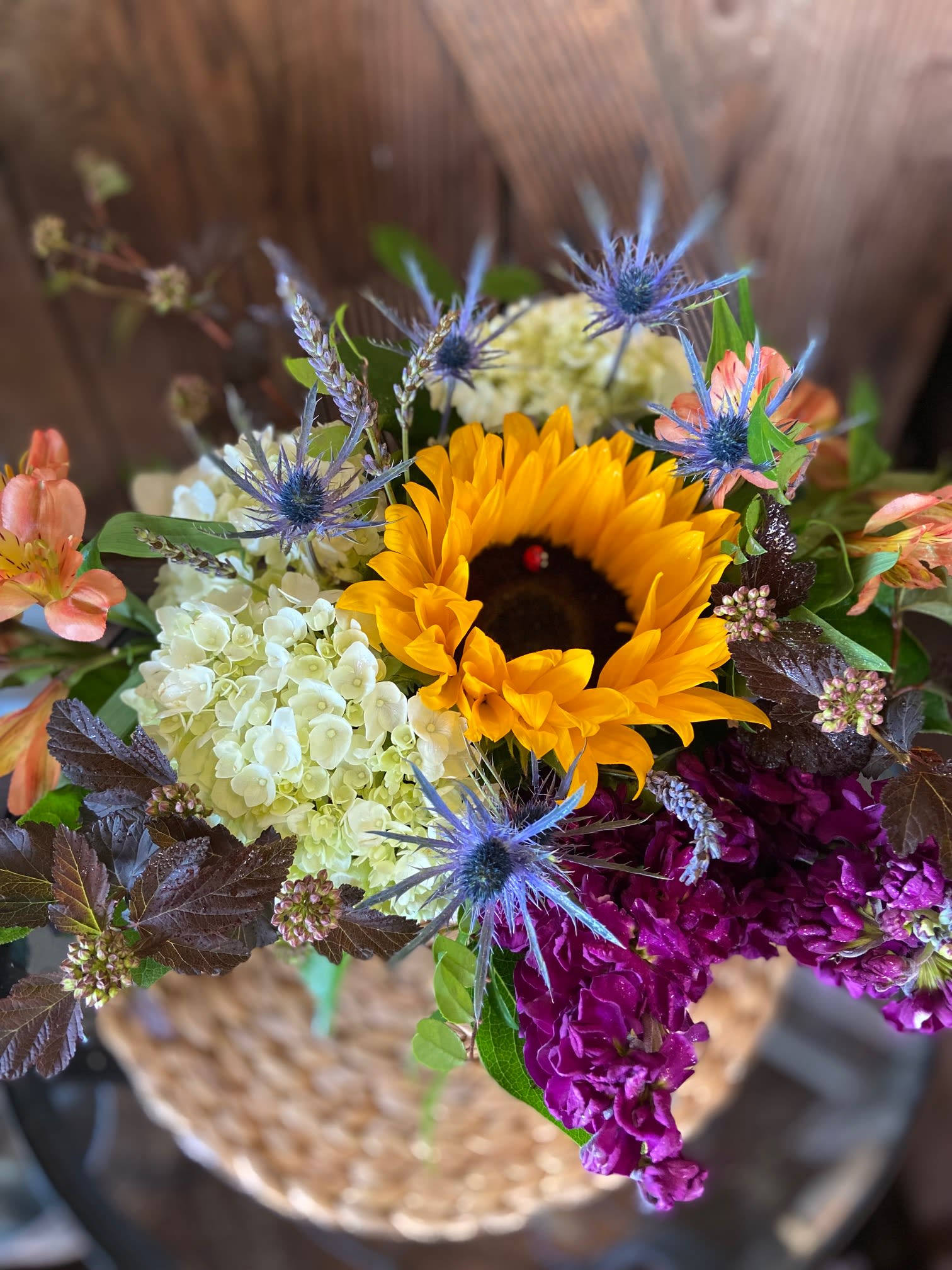 A Bit of Sunshine - Assortment of Summer Blooms Arranged Tastefully in a Birch Pot.