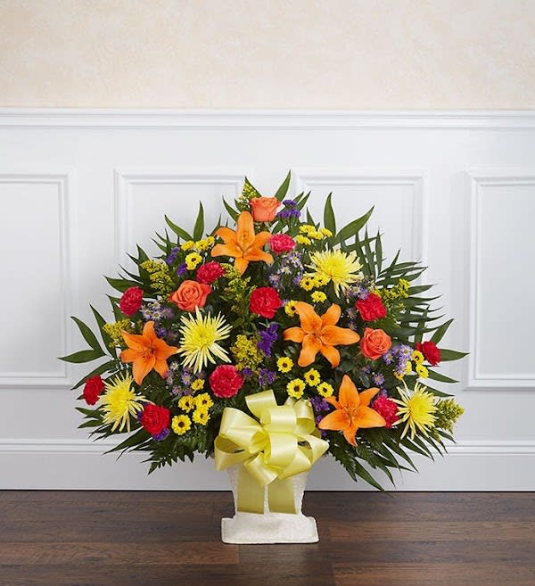 Heartfelt Tribute™ Floor Basket- Bright - They had a passion and exuberance that was undeniable. These qualities are captured in stories, memories and the vibrancy of our basket arrangement. This lush display of blooms in bright colors is beautifully crafted, creating an impressive tribute to celebrate their life.