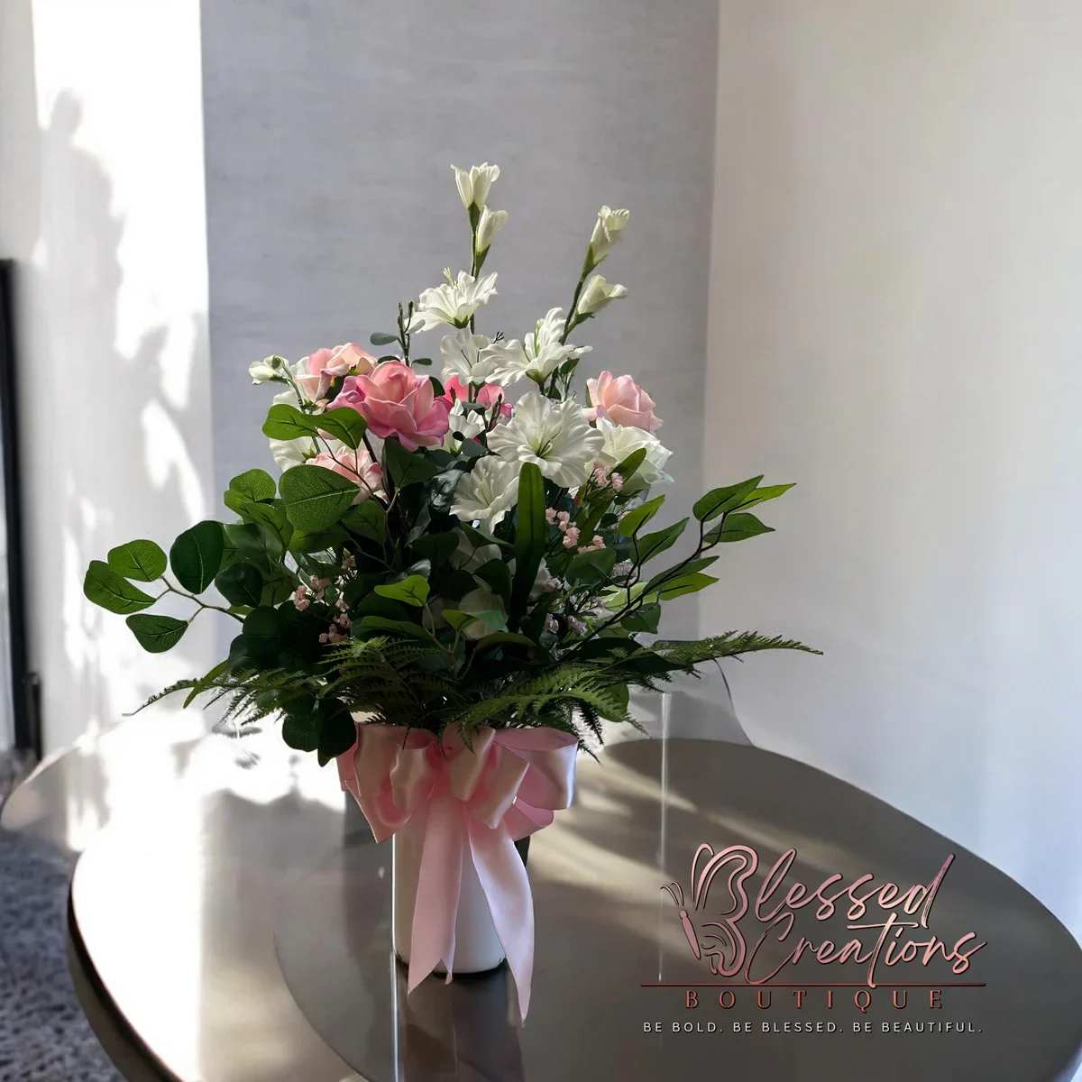 Pink/white silk floral arrangement - This pink and white silk floral arrangement is perfect for any occasion. Whether it's for sympathy, a birthday, or to bring cheer to a get well message, this versatile arrangement will brighten any room and add a touch of elegance to your home decor. Handcrafted with high-quality silk flowers, it's a long-lasting and low-maintenance option for those who appreciate beauty and convenience.