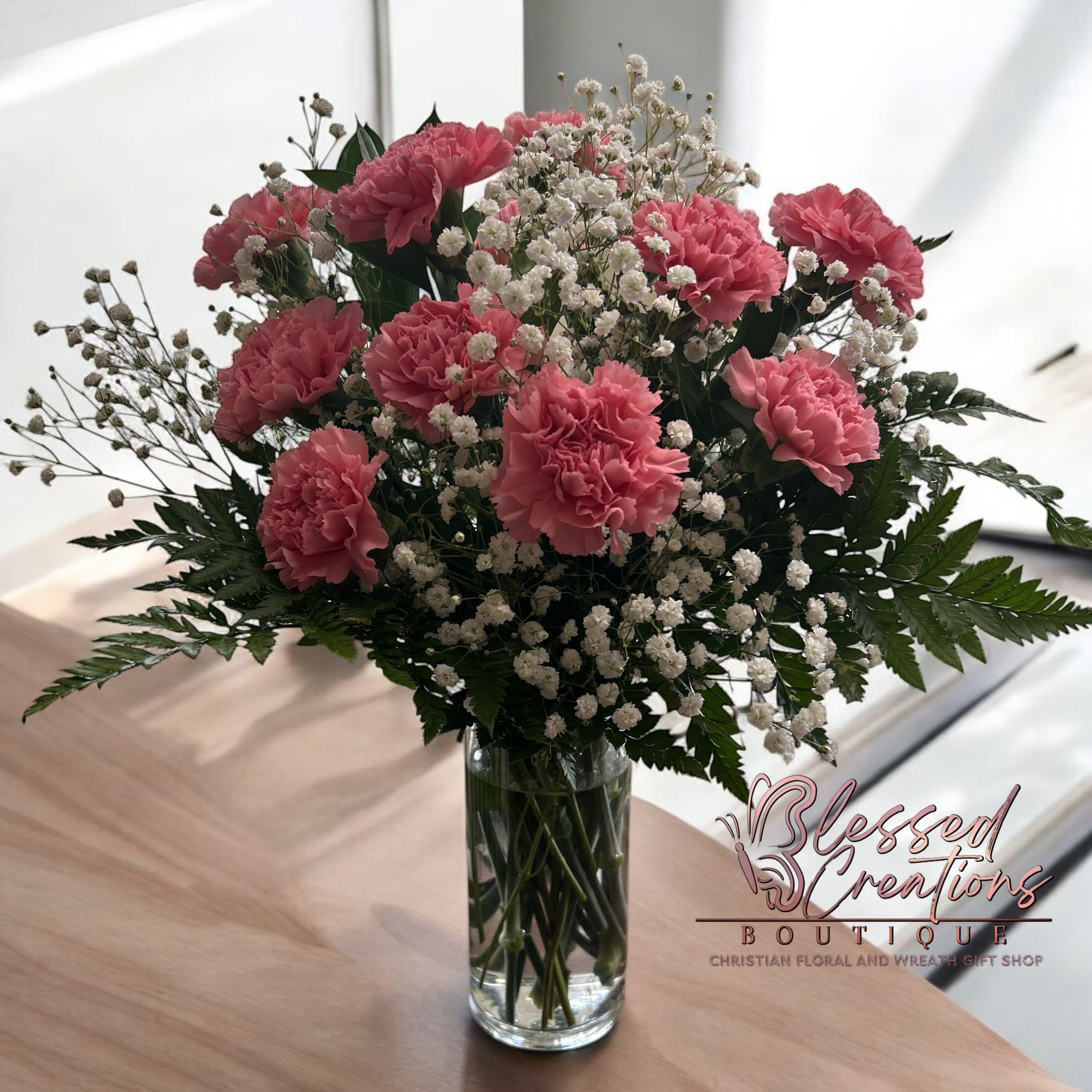 Pretty in pink carnations - Delicate and timeless, this arrangement features 12 lush pink carnations paired with baby’s breath, creating a look of pure elegance and charm. Brighten someone’s day today! 