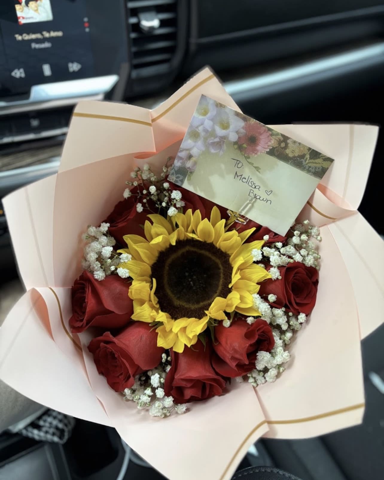 Everyday bouquet - 8 red roses with sunflower in the middle wrapped in paper