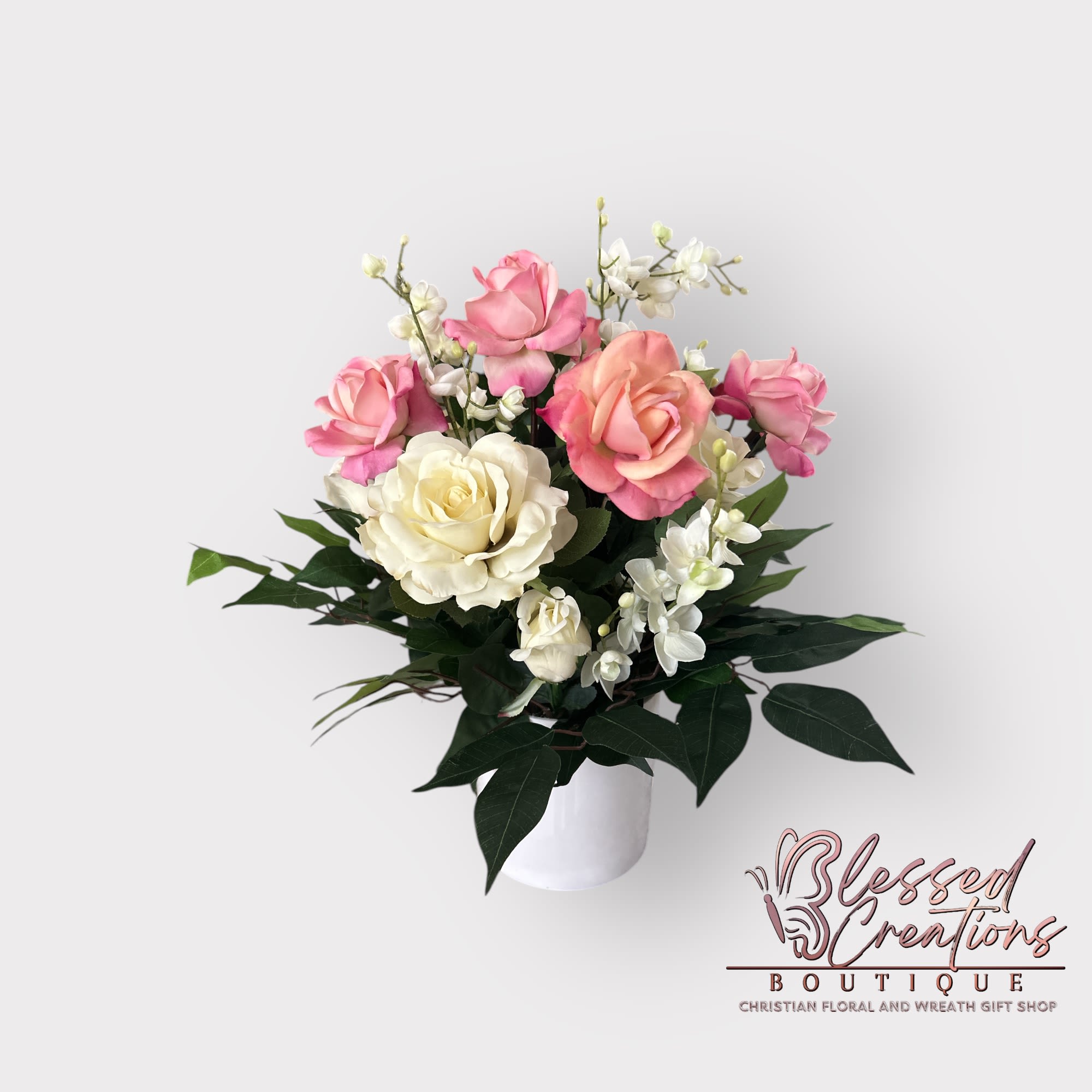 Pink and white medium silk rose arrangement  - This elegant medium silk floral arrangement features soft pink and classic white roses, beautifully accented with delicate white fillers and lush greenery. Great for sympathy arrangements, it offers a timeless and comforting presence, bringing beauty and peace to any space with its lifelike, maintenance-free design.