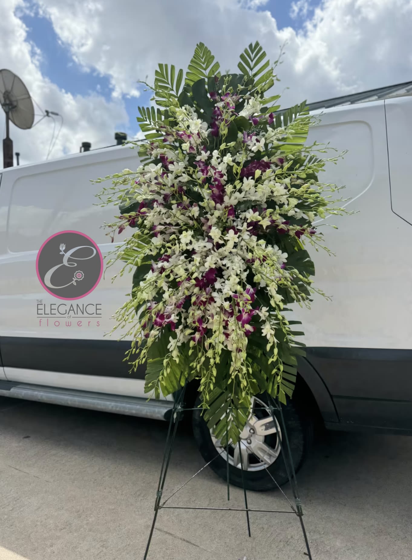 Costal Harmony Costal Harmony - A standings flower arrangement for a funeral service is a heartfelt tribute designed to honor and celebrate the life of the deceased. These arrangements are typically displayed on an easel or stand, making them highly visible and a central part of the memorial decor.