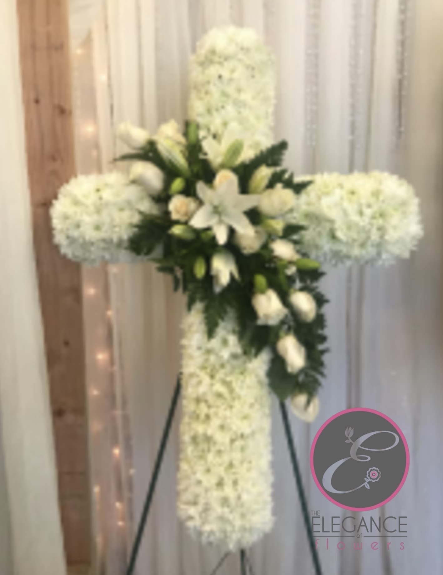 Cross Stand #4 Cross Stand #4 - Cross stand for a funeral is a graceful tribute, symbolizing faith and remembrance. Adorned with fresh flowers, it stands as a comforting centerpiece during memorial services.