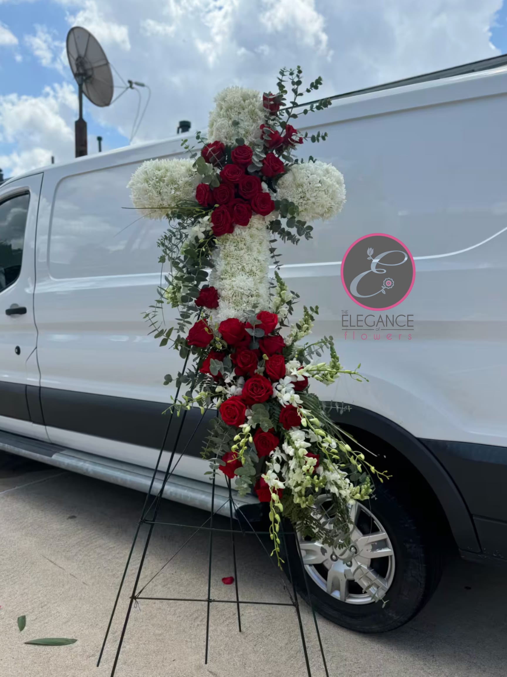 Cross Stand #5 Cross Stand #5 - A cross stand for a funeral is a graceful tribute, symbolizing faith and remembrance. Adorned with fresh flowers, it stands as a comforting centerpiece during memorial services.