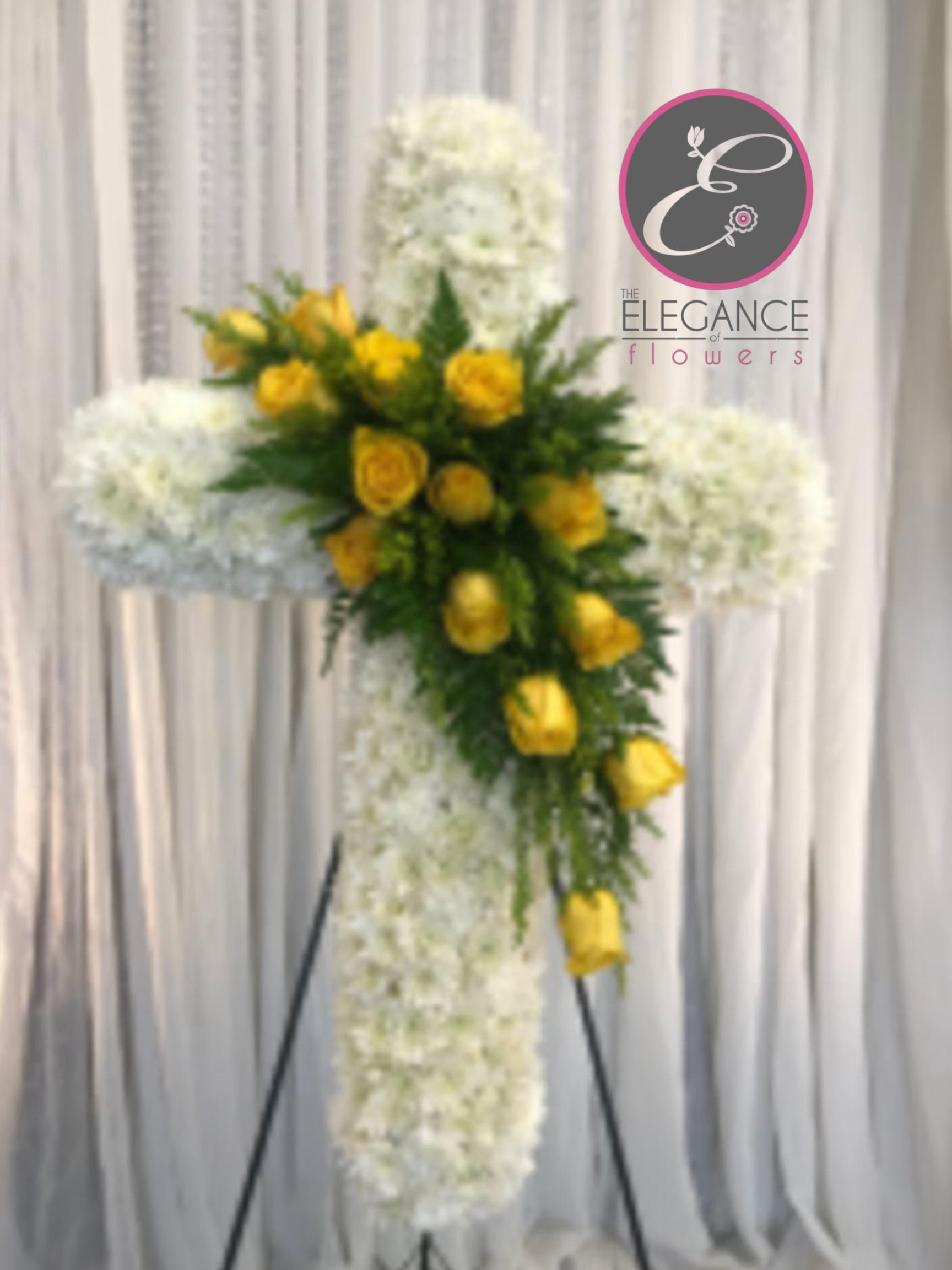 Cross Stand #8 Cross Stand #8 - Cross stand for a funeral is a graceful tribute, symbolizing faith and remembrance. Adorned with fresh flowers, it stands as a comforting centerpiece during memorial services.