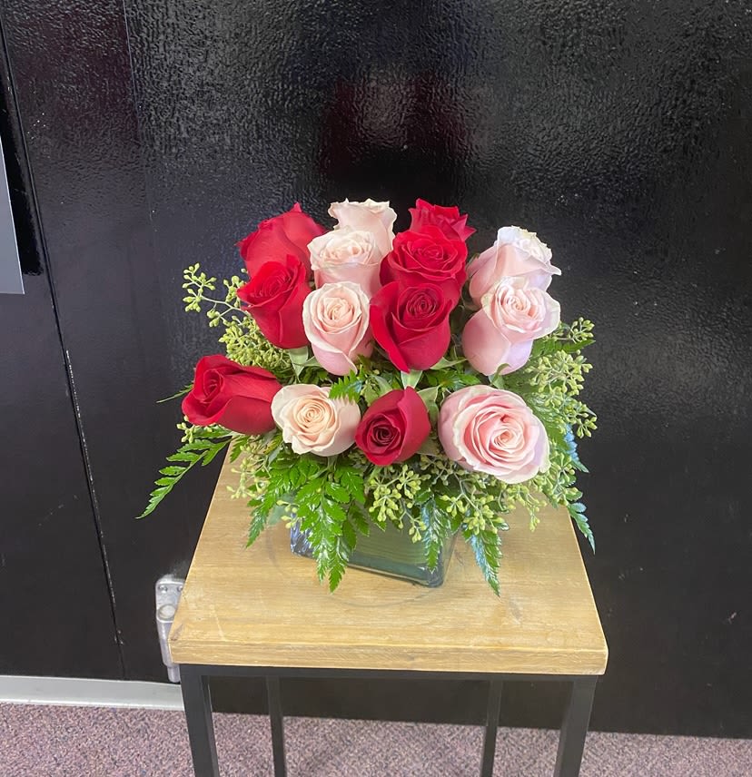 Sparks Fly by BloomNation™ - This rose combination is flirty, yet romantic. Sparks Fly by BloomNation™ the perfect gift for your first Valentine's Day.   Arrangement Details:  Includes a dozen roses in hot pink and red. APPROXIMATE DIMENSIONS: 10&quot; H, 11&quot; W, 11&quot;L 
