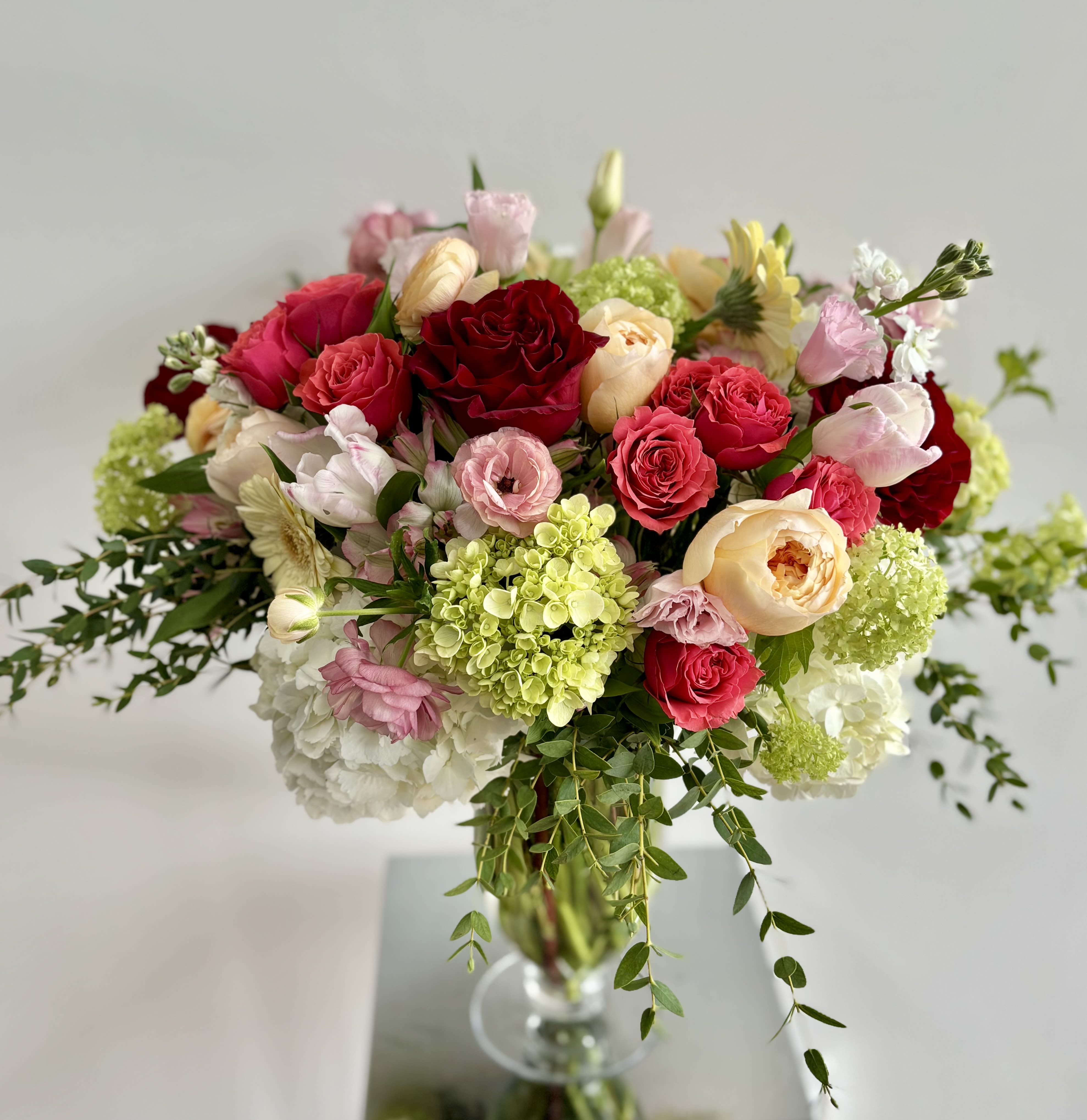 Beauty in Bloom Beauty in Bloom - Unique floral statement - a lush flower centerpiece arranged in a beautiful tall Charlotte glass vase. Colors and selection of premium flowers vary based on the availability. Michaela always carefully selects the best flower and color mix to reflect your occasion. If you have a preference for a color palette please leave a note for Michaela and she will do her best to accommodate you.