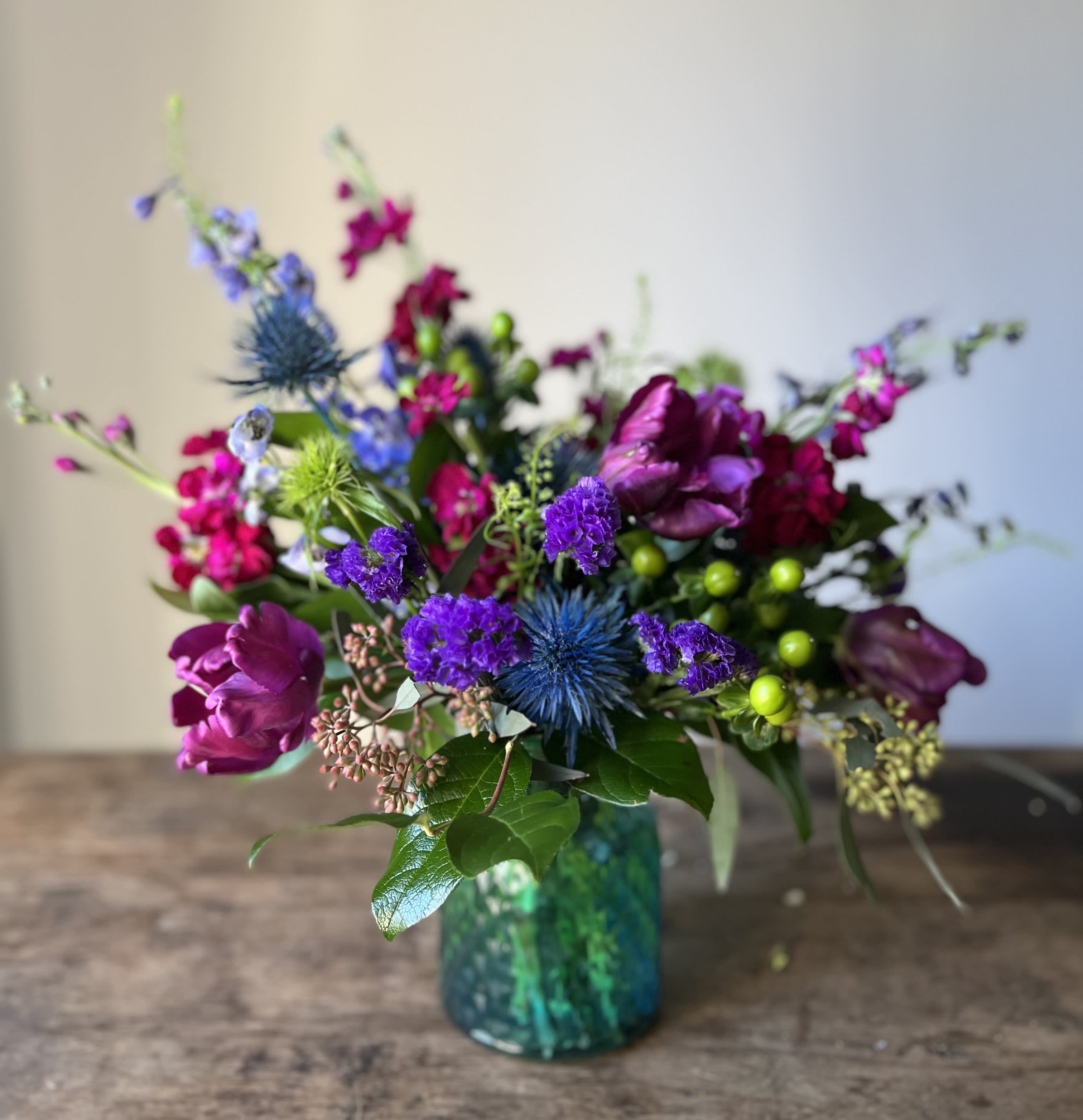 Jewels of the Sea Jewels of the Sea - Rich jewel tones blooms in blue-green vase.