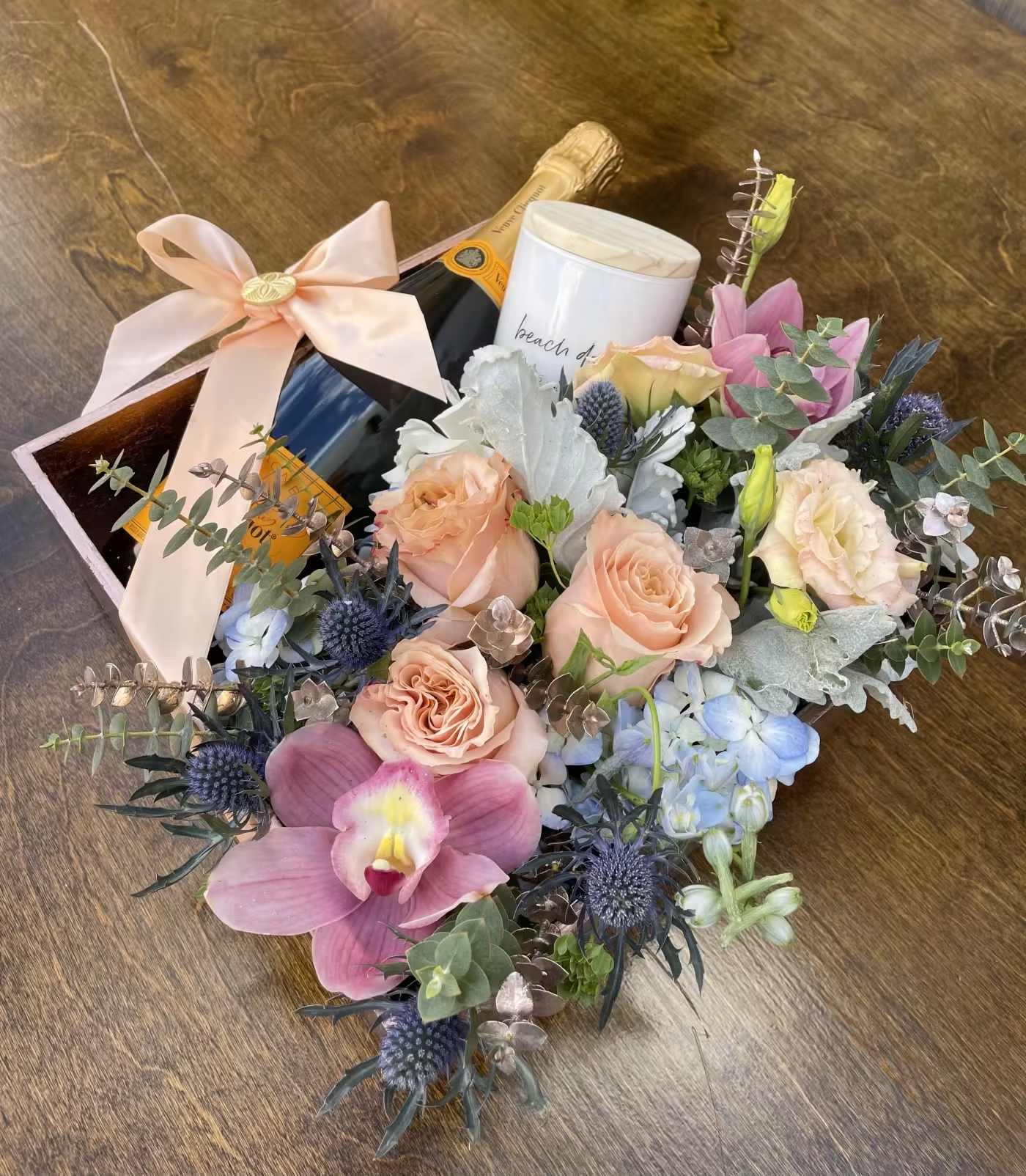A little "Vueve" Pink Me Up <3 A little "Vueve" Pink Me Up <3 - Elevate your gifting experience with this luxurious rose gold floral box, thoughtfully designed to make a lasting impression. Nestled inside are exquisite peach roses, delicately arranged alongside creamy white accent blooms and soft greenery to create an elegant, romantic statement. The arrangement is beautifully presented in a premium rose gold container and includes a bottle of Veuve Clicquot champagne, making it the perfect gift for anniversaries, celebrations, or special milestones. Ideal for luxury flower delivery in Los Angeles, this stunning floral and champagne pairing is a customer favorite for upscale occasions.