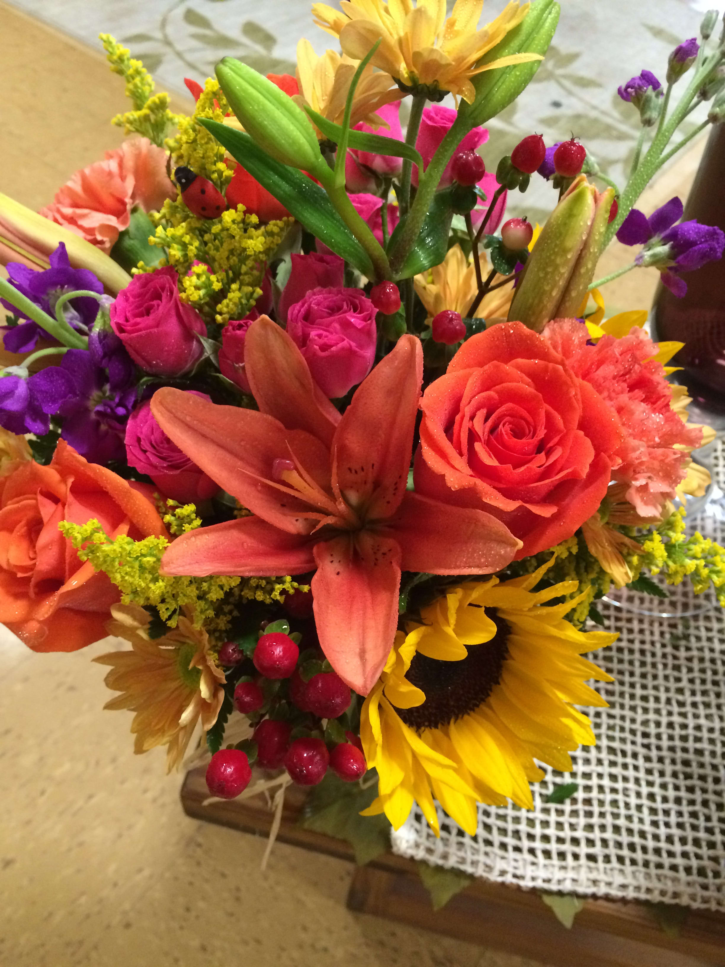 Color Breeze - A bright and colorful bouquet with a mixture of assorted seasonal flowers, sure to make whomever recieves them happy. Lillies, roses, sunfowers and berries just to name a few.