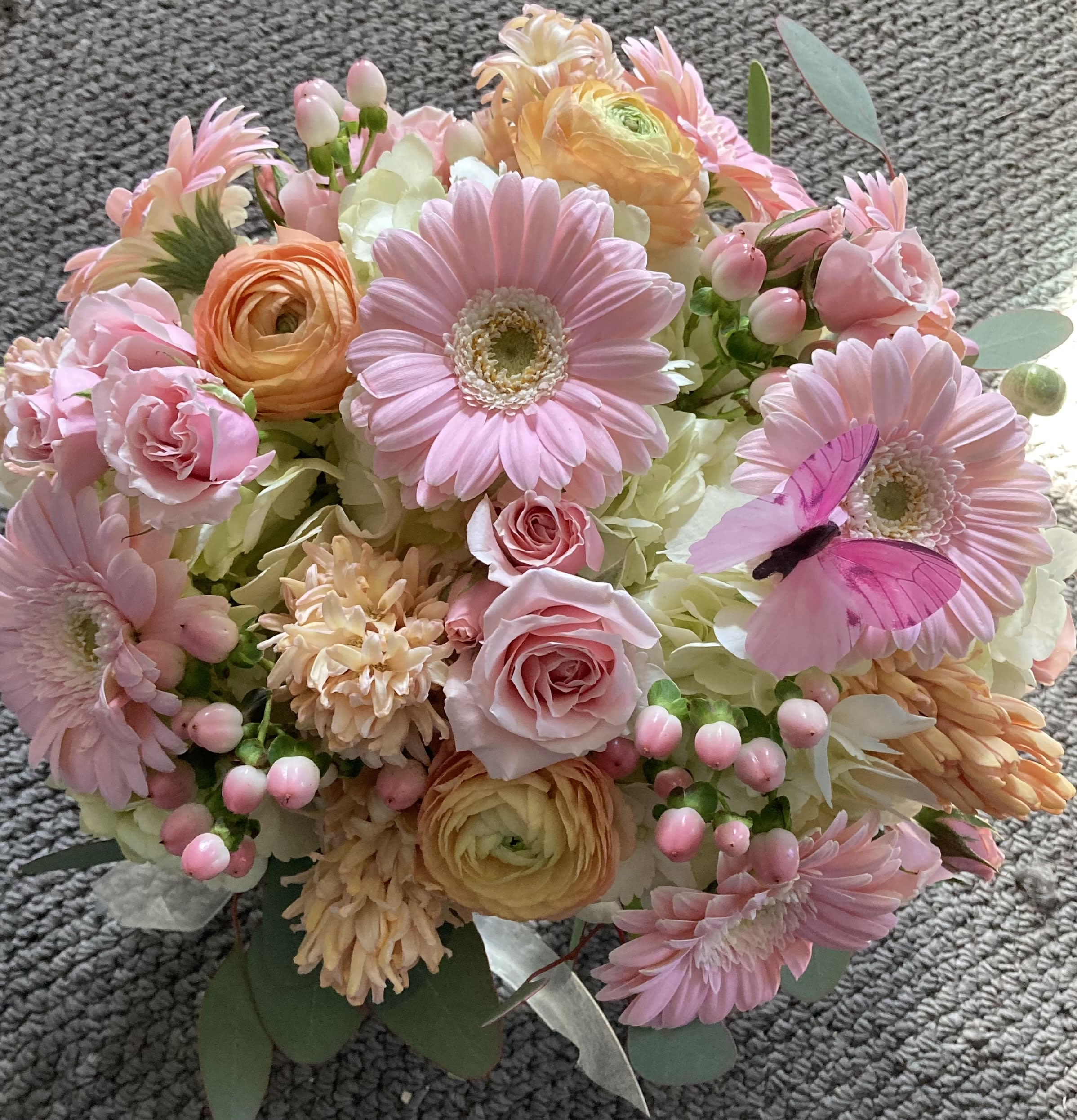 Oh Baby! - Pale pink and peach seasonal blooms, perfect for a new baby, an anniversary, or a birthday. Works for any occasion. Gerberas, spray roses, hydrangea, and hypericum berries.