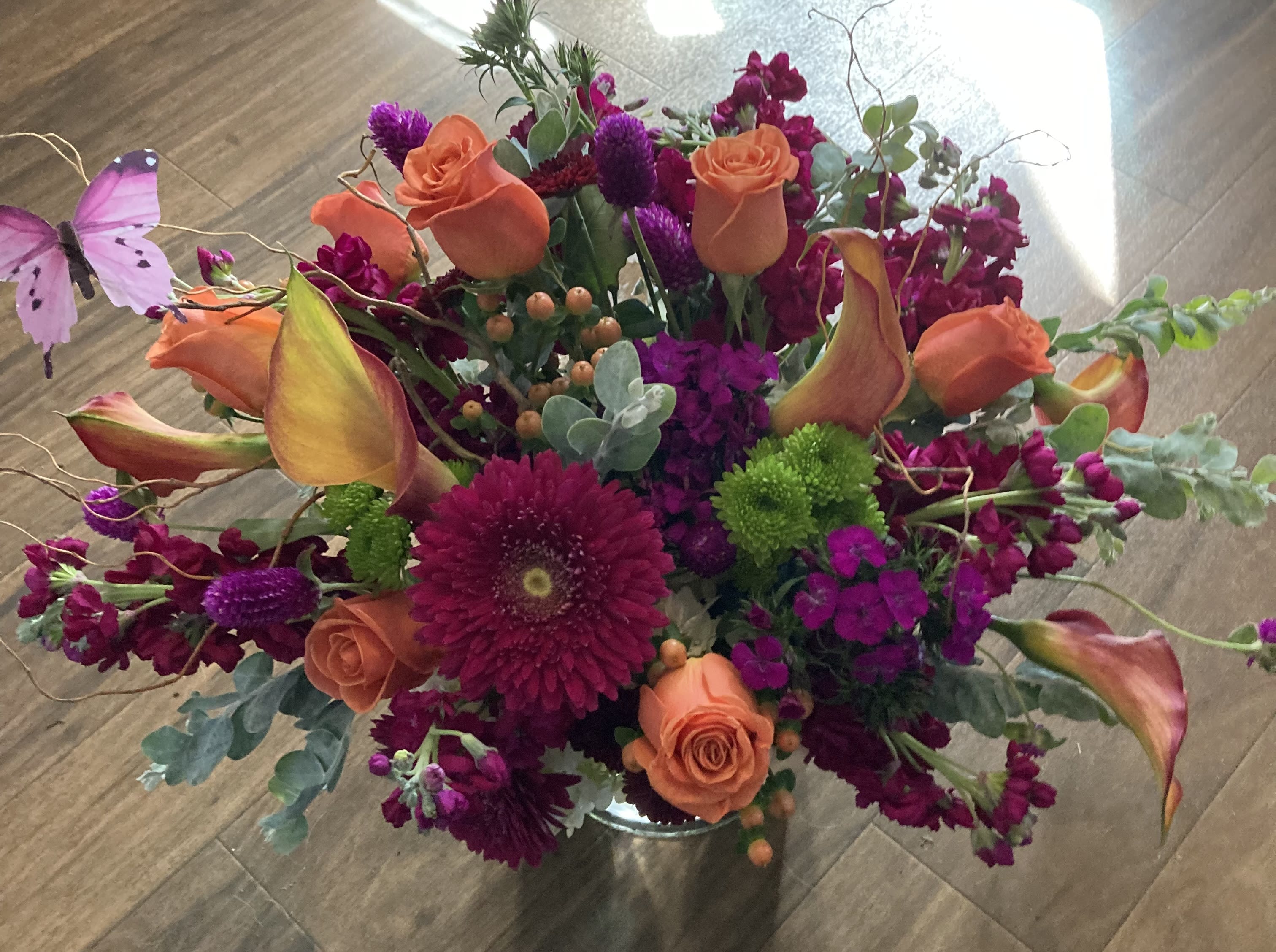 Splendor of Color - Bright colorful bouquet, with seasonal flowers in the colors of orange, purple, and green. Mango mini calla lilies, roses, gerberas, hypericum berries, and stock. Anniversary, birthday or any festive occasion.
