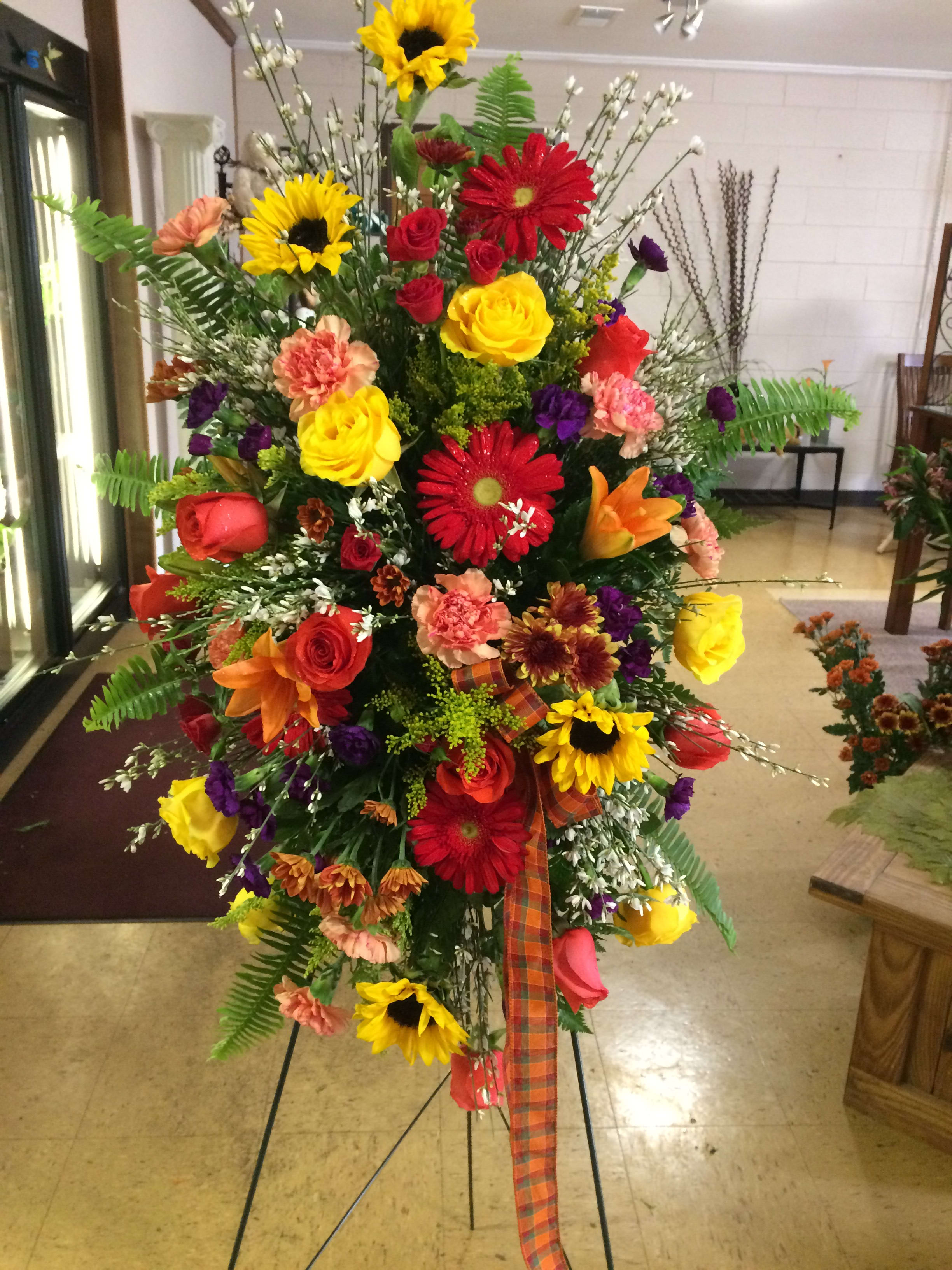 Sympathy Thoughts - A standing spray with multiple colors and flowes,r for a service and appropriate for graveside
