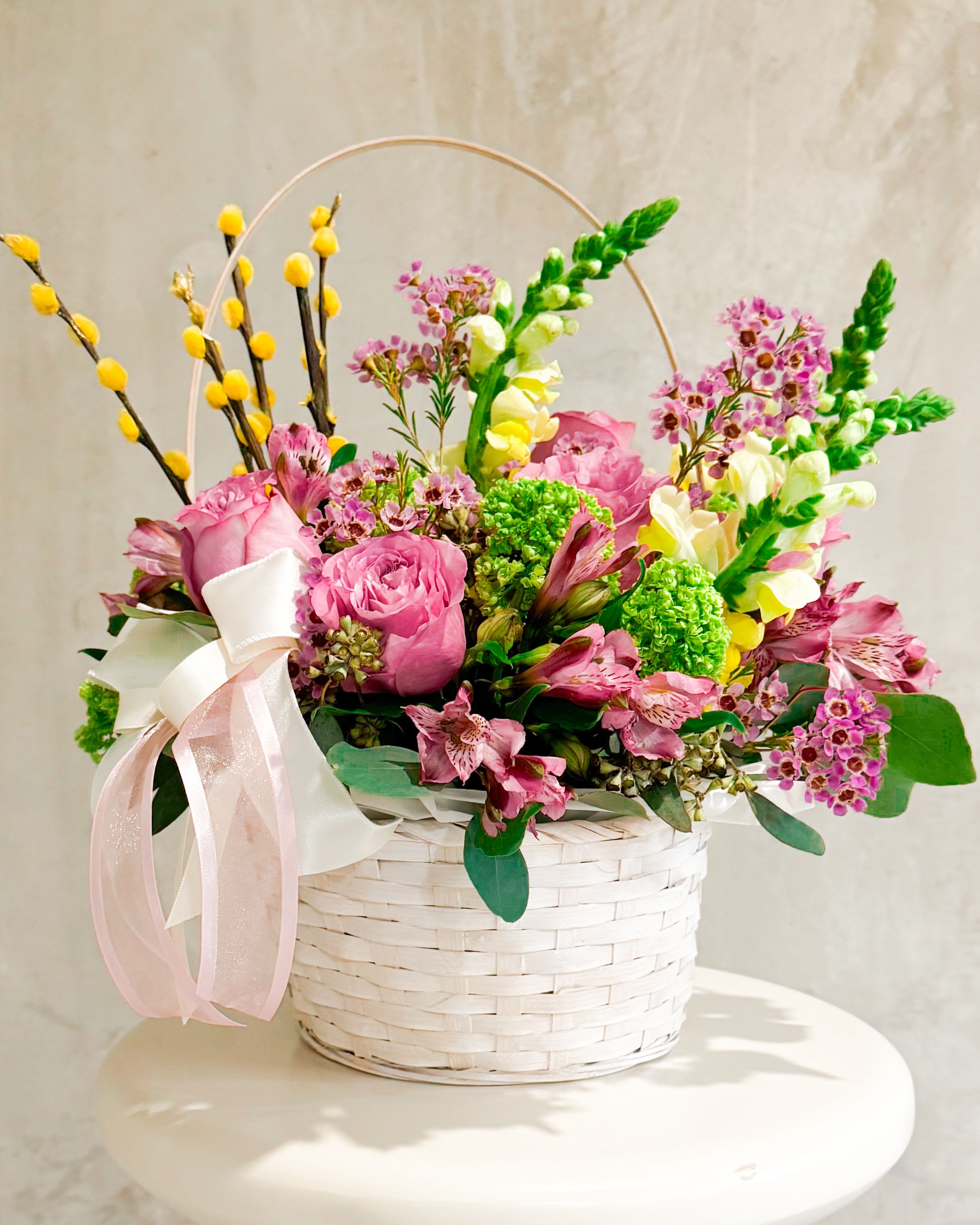 Festive Hampy - Say hi to Festive Hampy, your go-to basket of pure spring joy. Packed with poppin’ pinks, sunny yellows, and playful texture, this bouquet is all about good vibes and big “celebrate-the-little-things” energy. With its cute pastel ribbons and soft woven basket, it's basically your Easter mood board IRL. Think: brunch centerpiece, doorstep surprise, or just a little “I got you” moment.