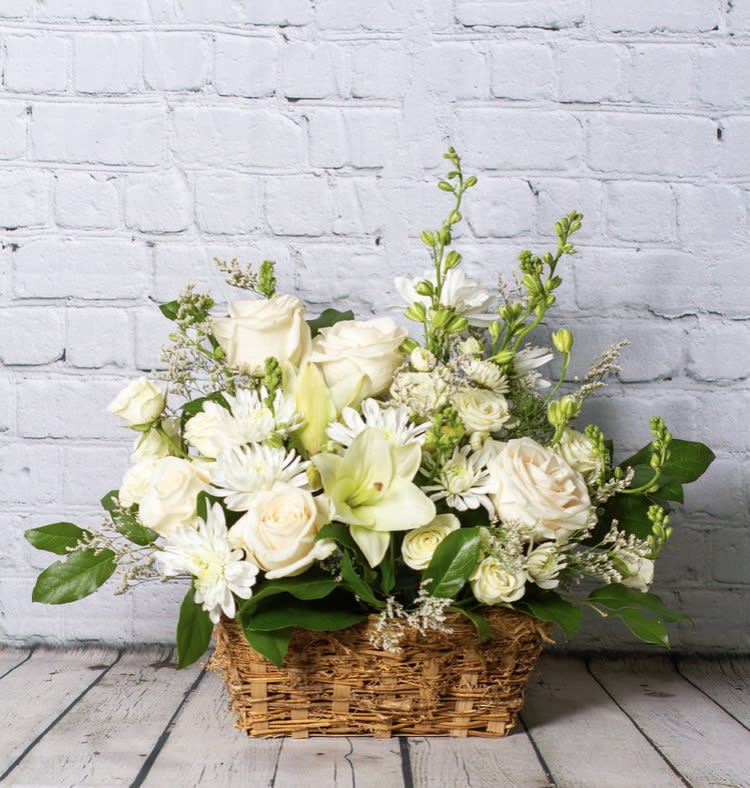 I Remember I Remember - During the difficulties that follow a loved one passing, we take the time to reflect on them and their lives. We have wonderful memories that can never fade, as they are written on our hearts. This one sided arrangement was designed with lilies, roses, larkspur, chrysanthemums, and spray roses. Please Note: Standard Delivery for this product occurs in the afternoon, between 2:30pm and 7pm. If you need it by a certain time, there is an option to select a timed window for scheduled deliveries. Please Note: Standard Delivery for this product occurs in the afternoon, between 2:30pm and 7pm. If you need it by a certain time, there is an option to select a timed window for scheduled deliveries. PLEASE NOTE: The actual basket may be different than the one pictured, depending on supply chain issues. Thank you for your understanding.