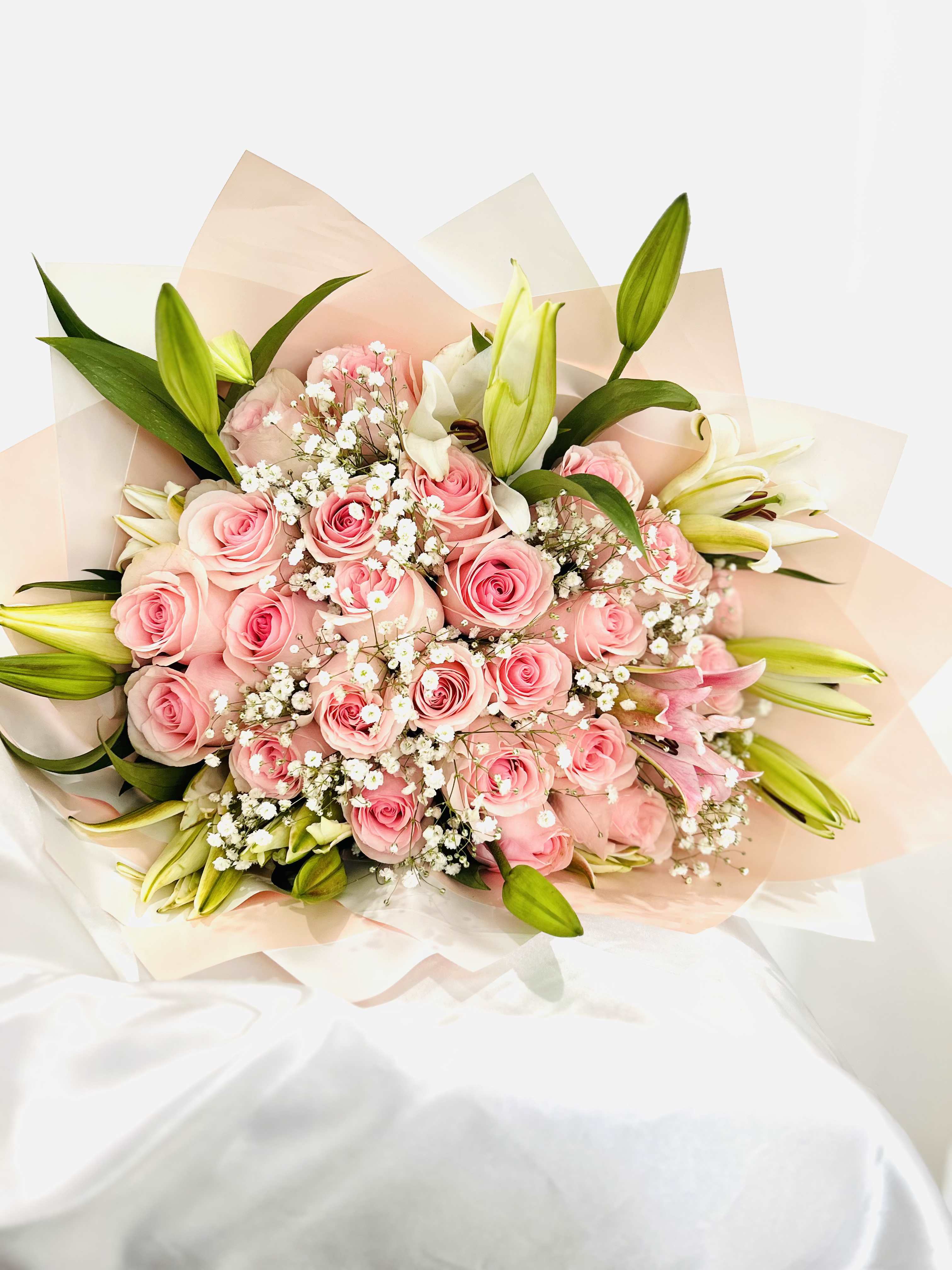 Rose and Lilies - Medium hand wrapped bouquet with roses and lilies.