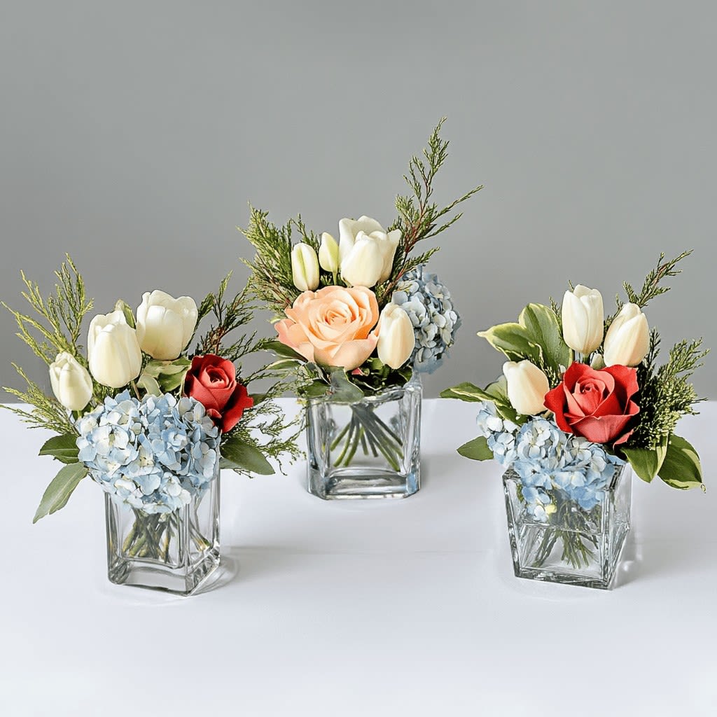 Tulip Trio Tulip Trio - Want to tip-toe through the tulips? Our Tulip Trio will create excitement around your table. Flowers like tulips, roses, and hydrangea are tastefully arranged in three cubes to stage together or separately.