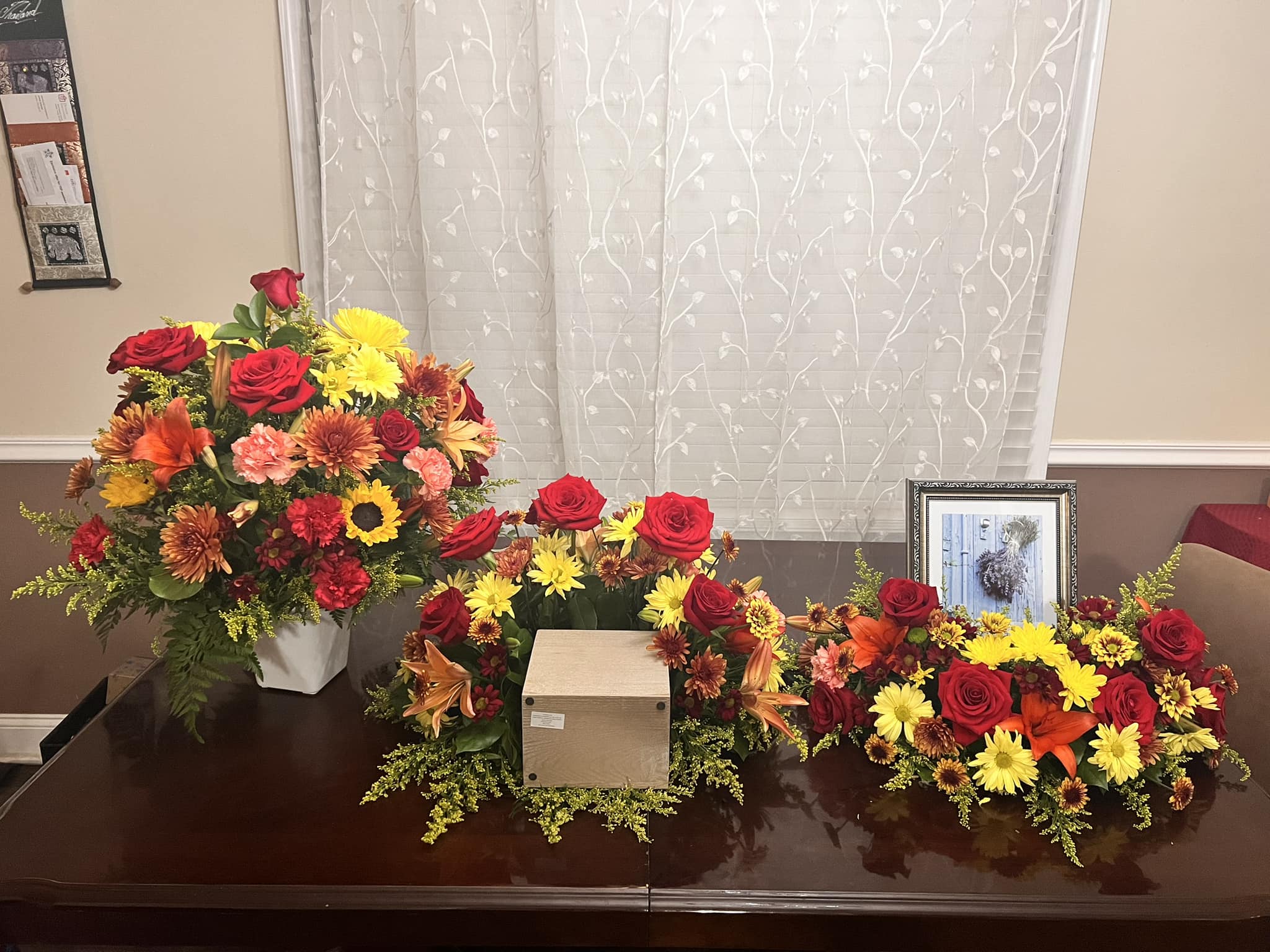 Trio Funeral Cremation Tribute Package Trio Funeral Cremation Tribute Package - Fall colors Funeral Cremation Tribute package as shown in picture, "S" shape arrangement and a vase of flowers.