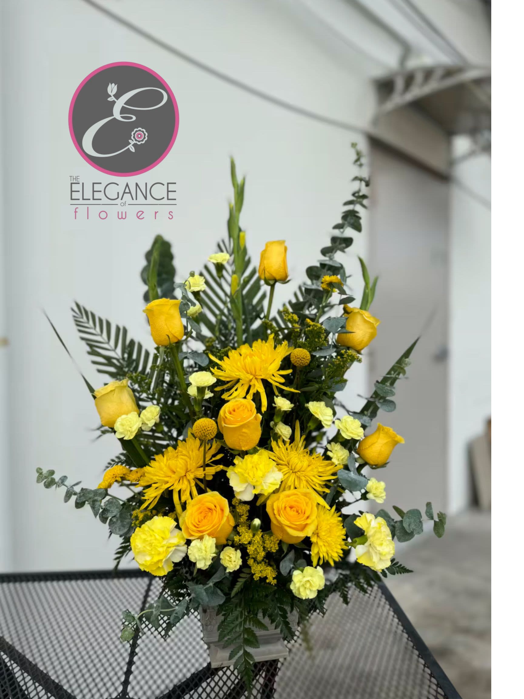 Pedestal Arrangement #10 Pedestal Arrangement #10 - A sympathy pedestal arrangement offers a heartfelt expression of condolence, featuring a carefully curated selection of serene and elegant blooms. Designed to convey comfort and peace, each arrangement is thoughtfully crafted with soft hues and gentle fragrances, providing a soothing presence during times of loss.