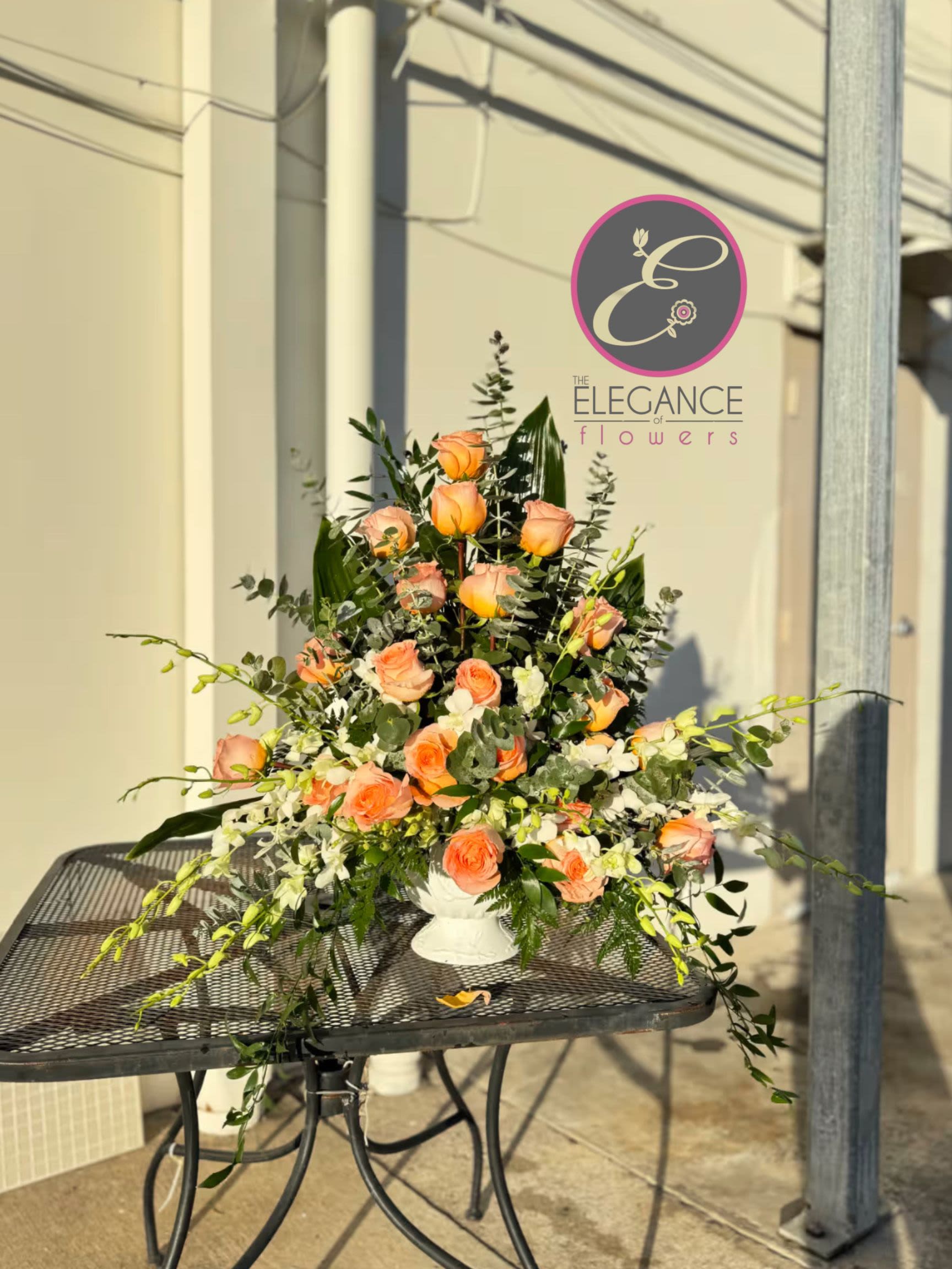Pedestal Arrangement #4 Pedestal Arrangement #4 - A sympathy pedestal arrangement offers a heartfelt expression of condolence, featuring a carefully curated selection of serene and elegant blooms. Designed to convey comfort and peace, each arrangement is thoughtfully crafted with soft hues and gentle fragrances, providing a soothing presence during times of loss.
