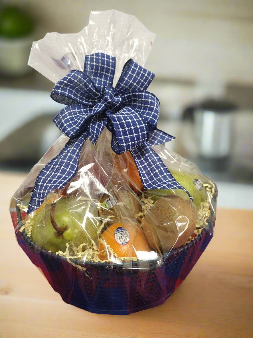 Fruit Basket - Indulge in our exquisite assortment of fresh fruit, beautifully arranged in a designer's choice basket or container. Each selection is thoughtfully wrapped in cellophane and adorned with a charming bow, making it a perfect gift for any occasion. Please allow at least 24 hours' notice for basket orders, and kindly inform us of any allergies or preferences in the notes section to ensure a delightful experience.