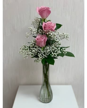Pink Rose Bud Vase - 3 beautiful pink roses arranged with greens and filler in a bud vase. A great way to make a statement without being overwhelming
