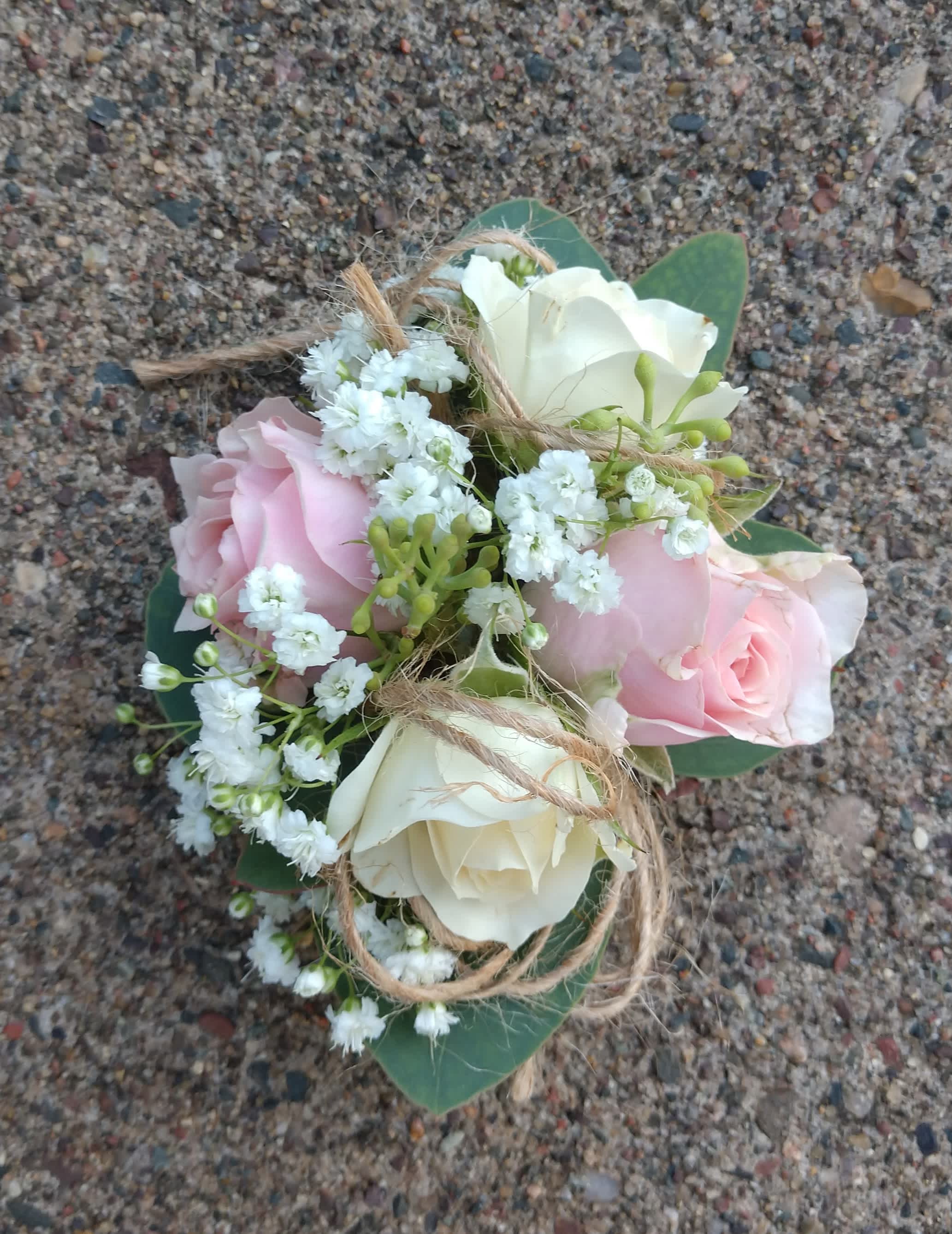 Country Sweet Wrist Corsage  - White and pink roses paired with a twine bow for a country casual look. This corsage includes an elastic disposable wristlet.