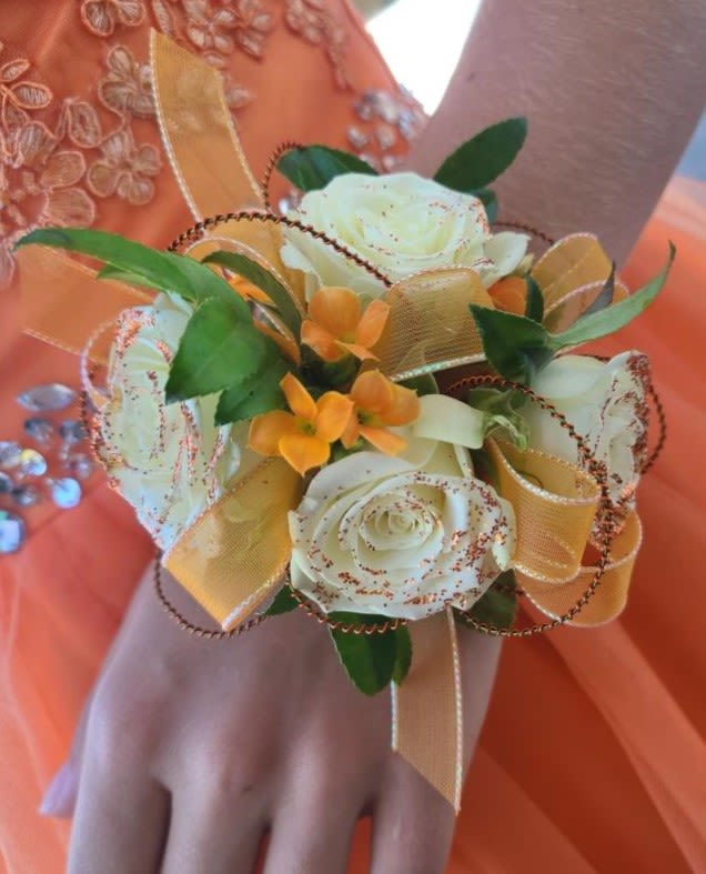 Siren Wrist Corsage Siren Wrist Corsage - White spray roses accented with orange kalanchoe blooms and copper wires and glitter.