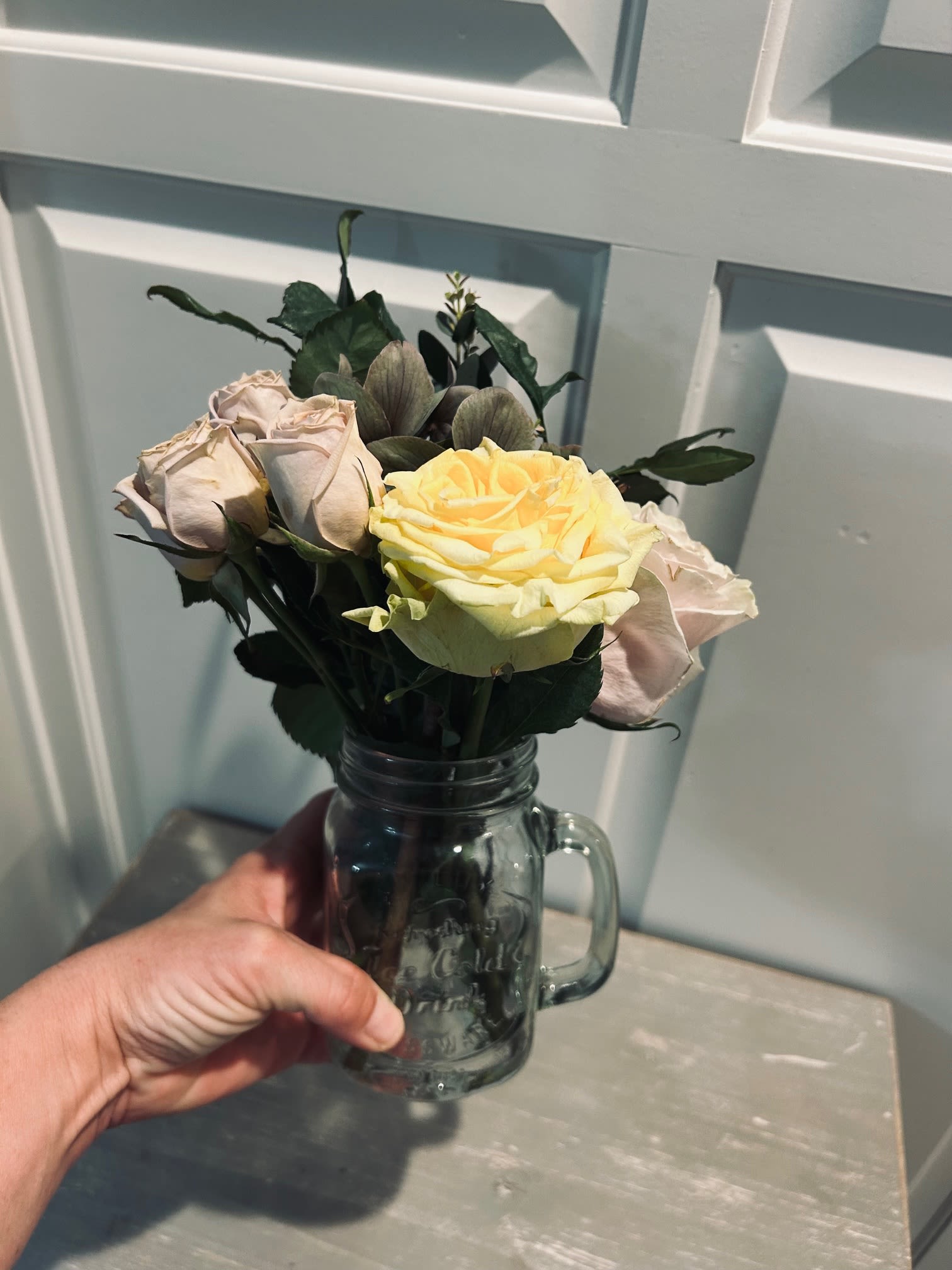 A Jar of Joy - A small glass mason jar delicately arranged and prepared with fresh cut roses, and foliage. Available in all colors.