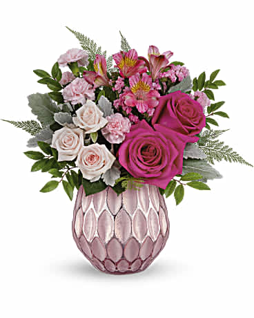 Pretty Love Bouquet - Keep 'em blushing this Valentine's Day with the prettiest pink roses, presented to perfection in a sculpted pink glass vase with a fabulously frosted, faux mercury glass finish. This arrangement features hot pink roses, light pink spray roses, dark pink alstroemeria, miniature pink carnations, pink sinuata statice, dusty miller, huckleberry and leatherleaf fern. This perfectly pink bouquet is delivered in Teleflora's Pretty Love Vase. Orientation: All-Around