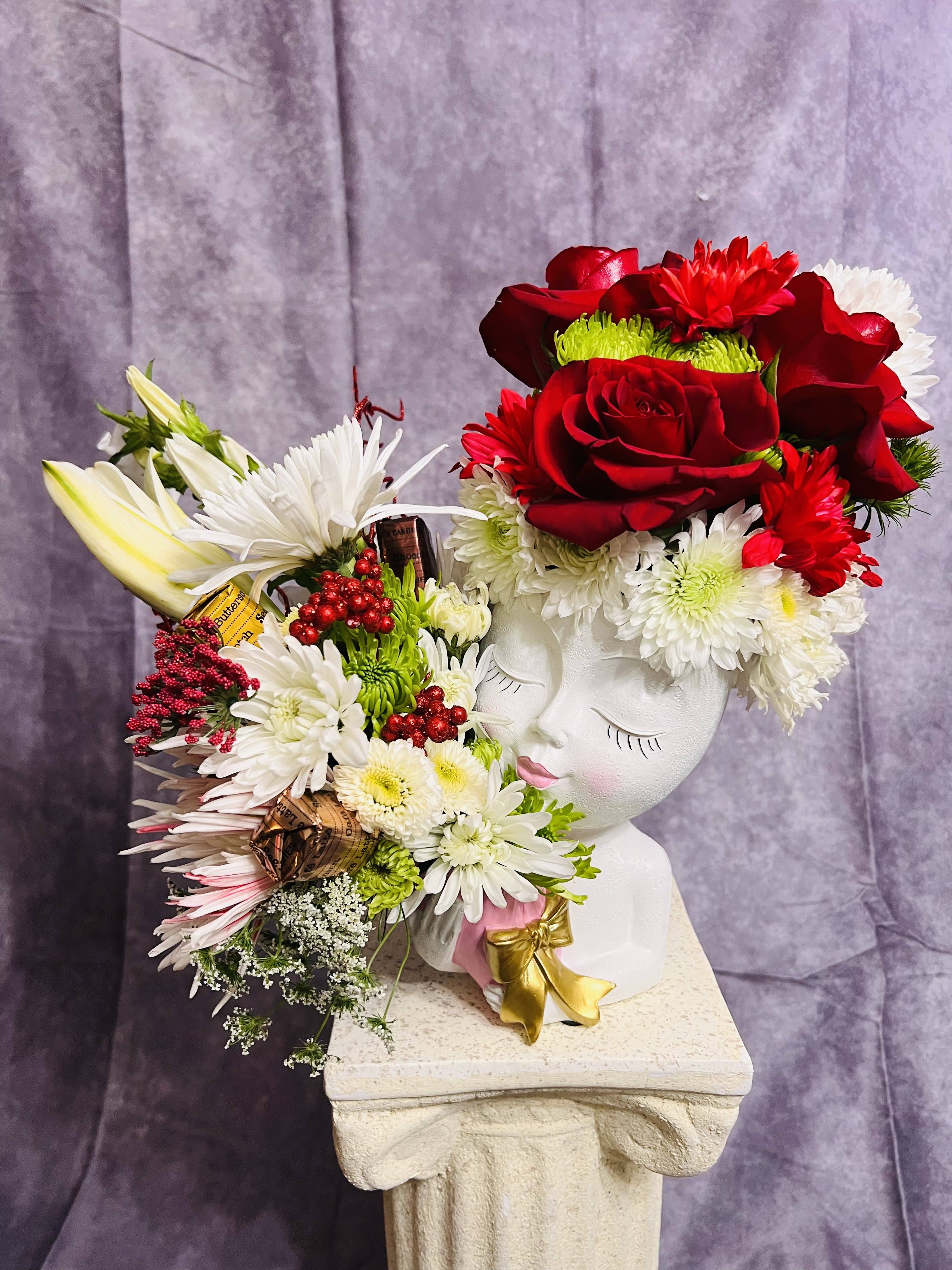 Lovely Lady in Holiday Hat with Bouquet  Lovely Lady in Holiday Hat with Bouquet  - Merry Christmas with lovely lady in her Holiday hat and special gifts with See’s Candies lollipop included.  We can also custom your color theme; please specify in the notes for the florist/special instructions before you check out.