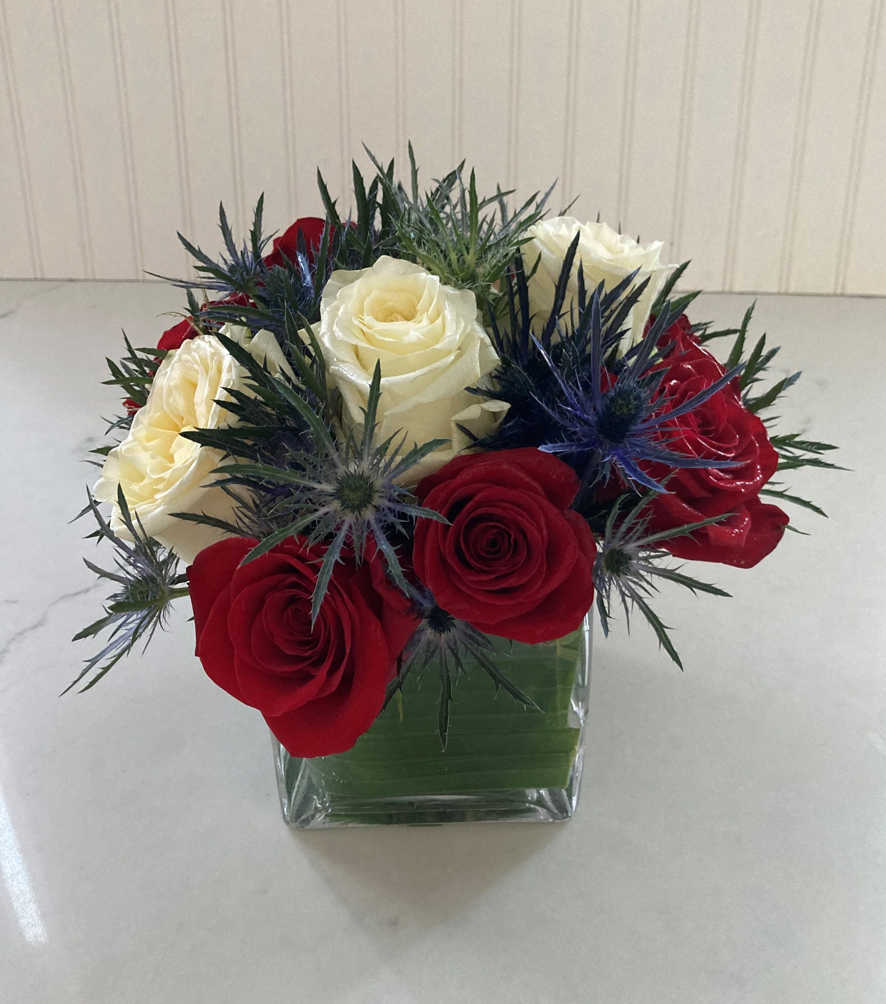 The Patriot - Boldly crossing all party lines The Patriot is here to celebrate your favorite star spangled firecracker days, blue thistle and red and white roses artfully designed in clear glass. 