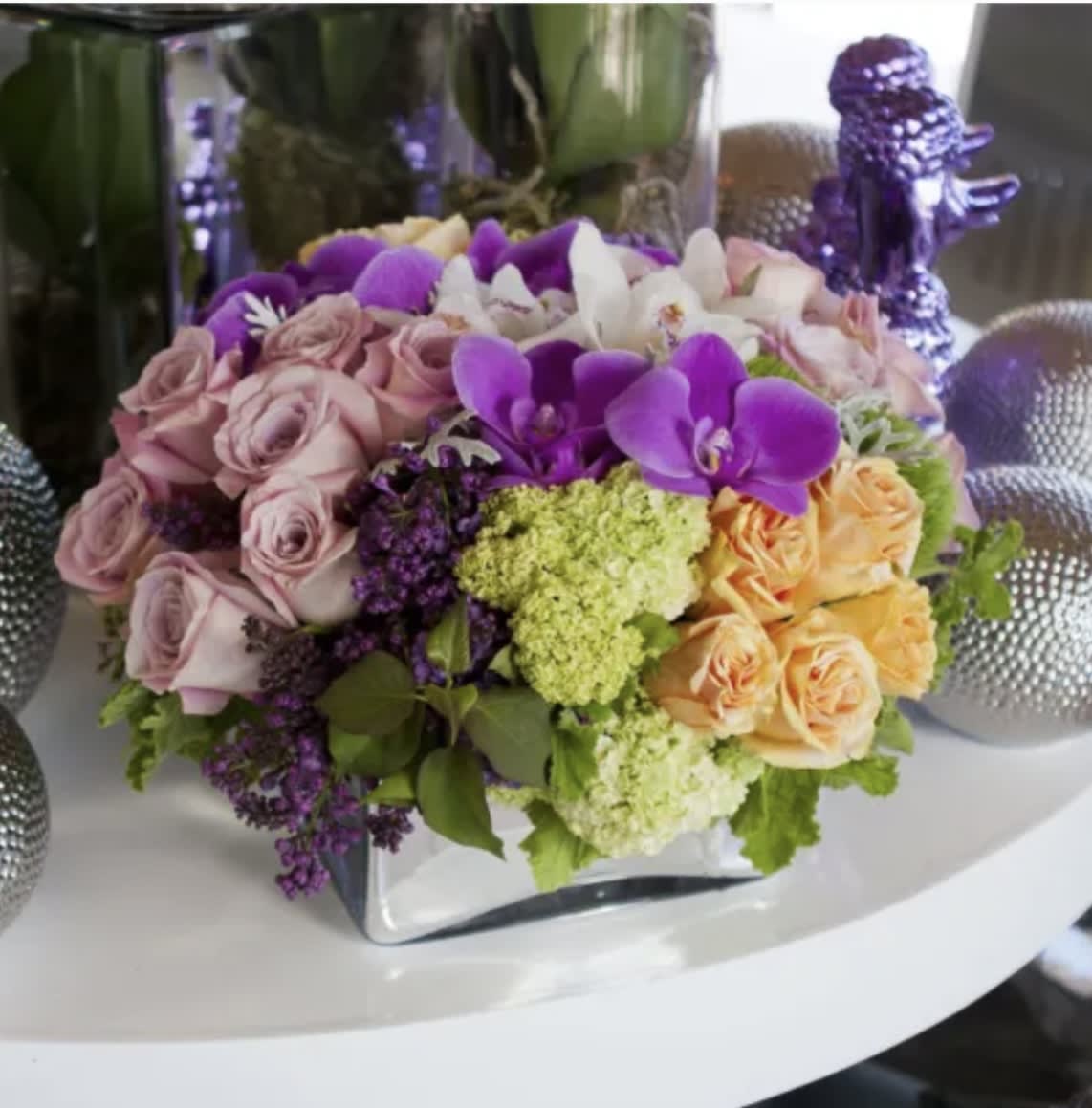 Luscious Lilacs Luscious Lilacs - Gorgeous bouquet of lilac, orchids, roses and more stylishly arranged in glass vase
