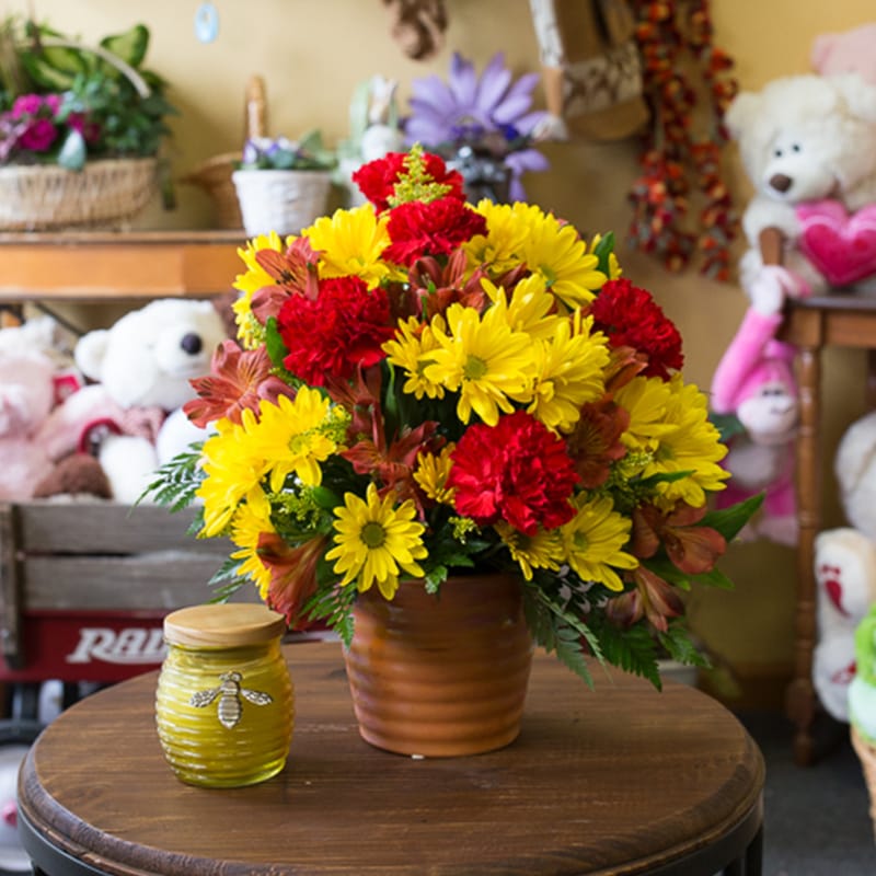 Pleasant Day Bouquet Pleasant Day Bouquet - Winter, Spring, Summer or Fall these pretty flowers fit them all. Filled with Yellow Daisies, Red Carnations and Orange Alstoemeria.