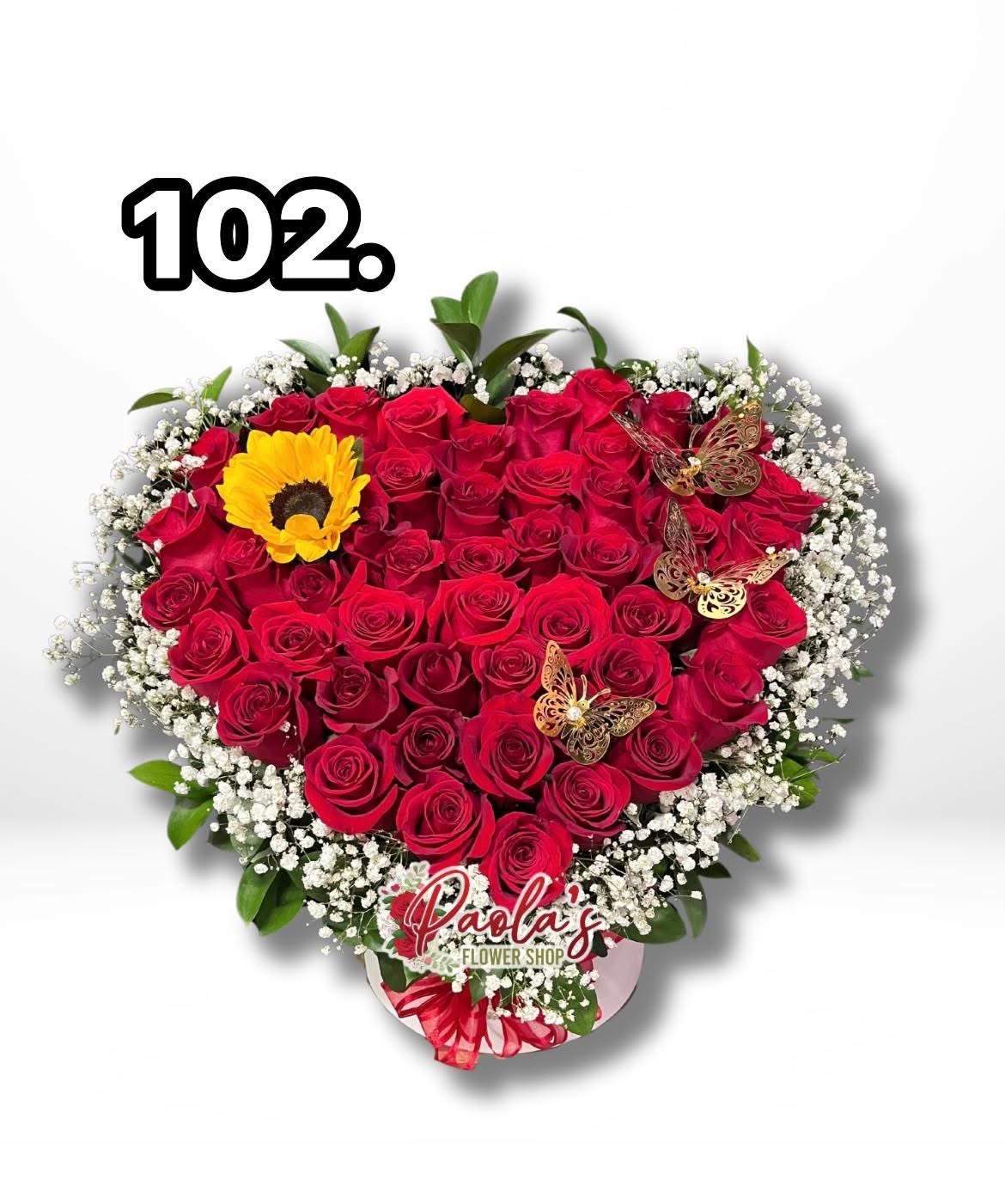 Oh my love!  - Heart shaped out of roses with sunflower surrounded with filler and greens! 