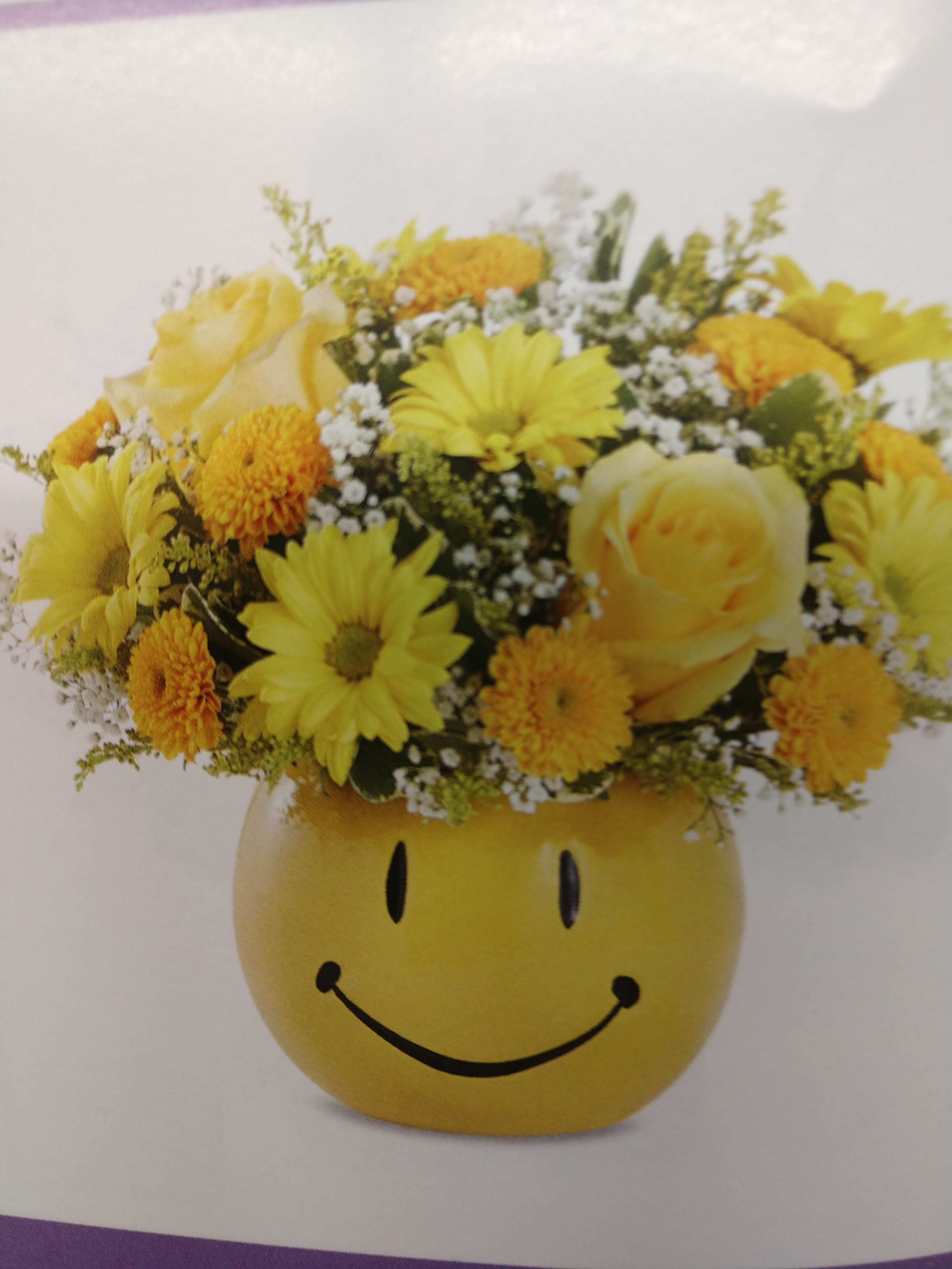 Brighten Their Day with a Smile Bouquet Brighten Their Day with a Smile Bouquet - Brighten Their Day with a Smiley Bouquet In a Smiley Container with a Smiley Mylar Balloon. All done in yellow to brighten their day.